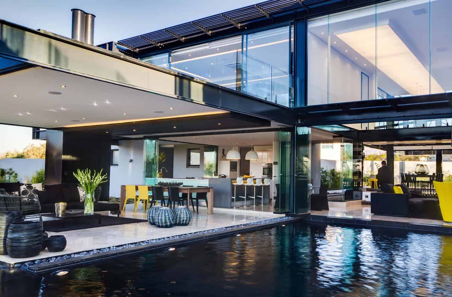 contemporary glass house with a pool