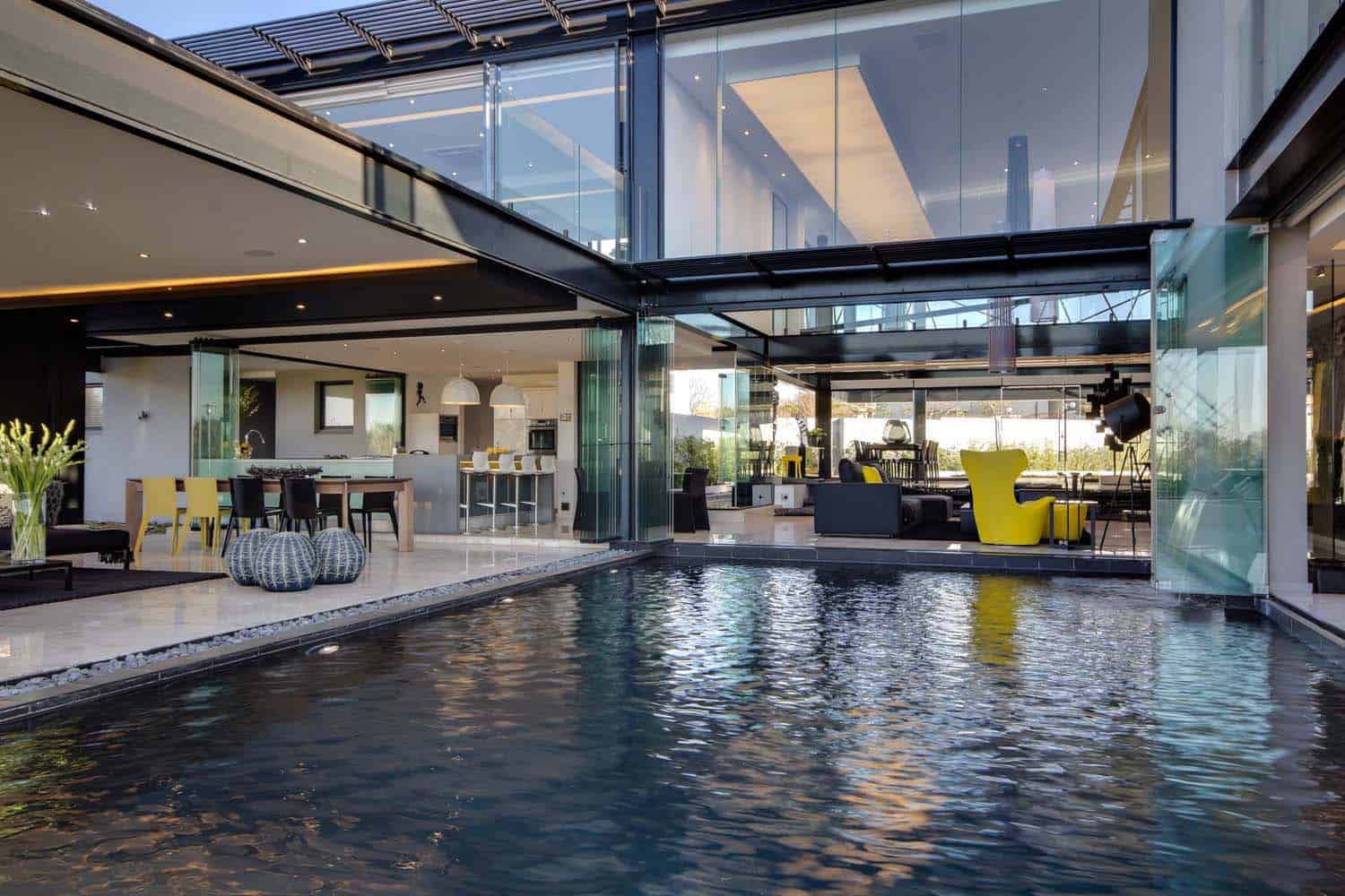 contemporary glass house with a pool