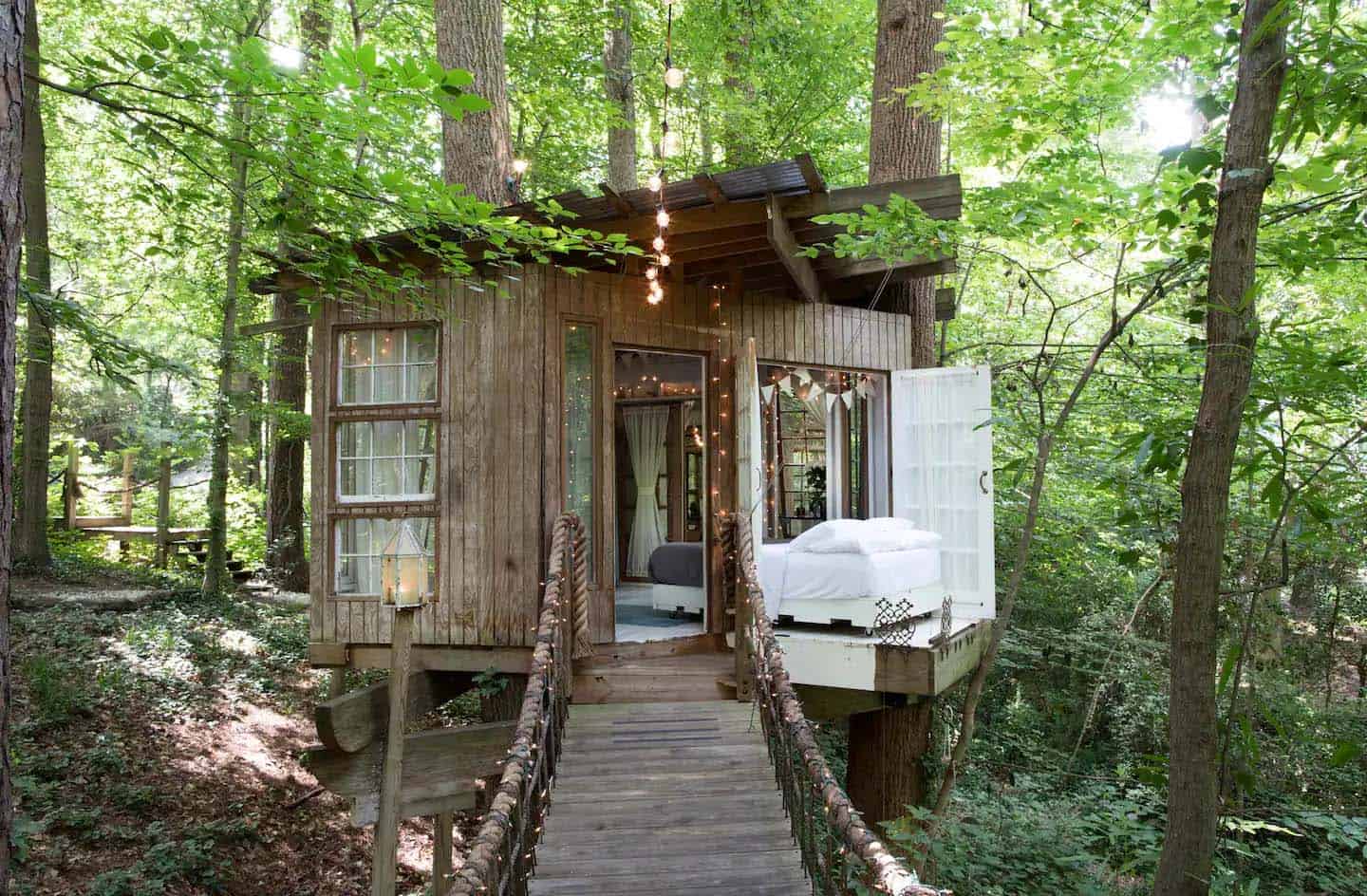 treehouse exterior in a forest with string lights