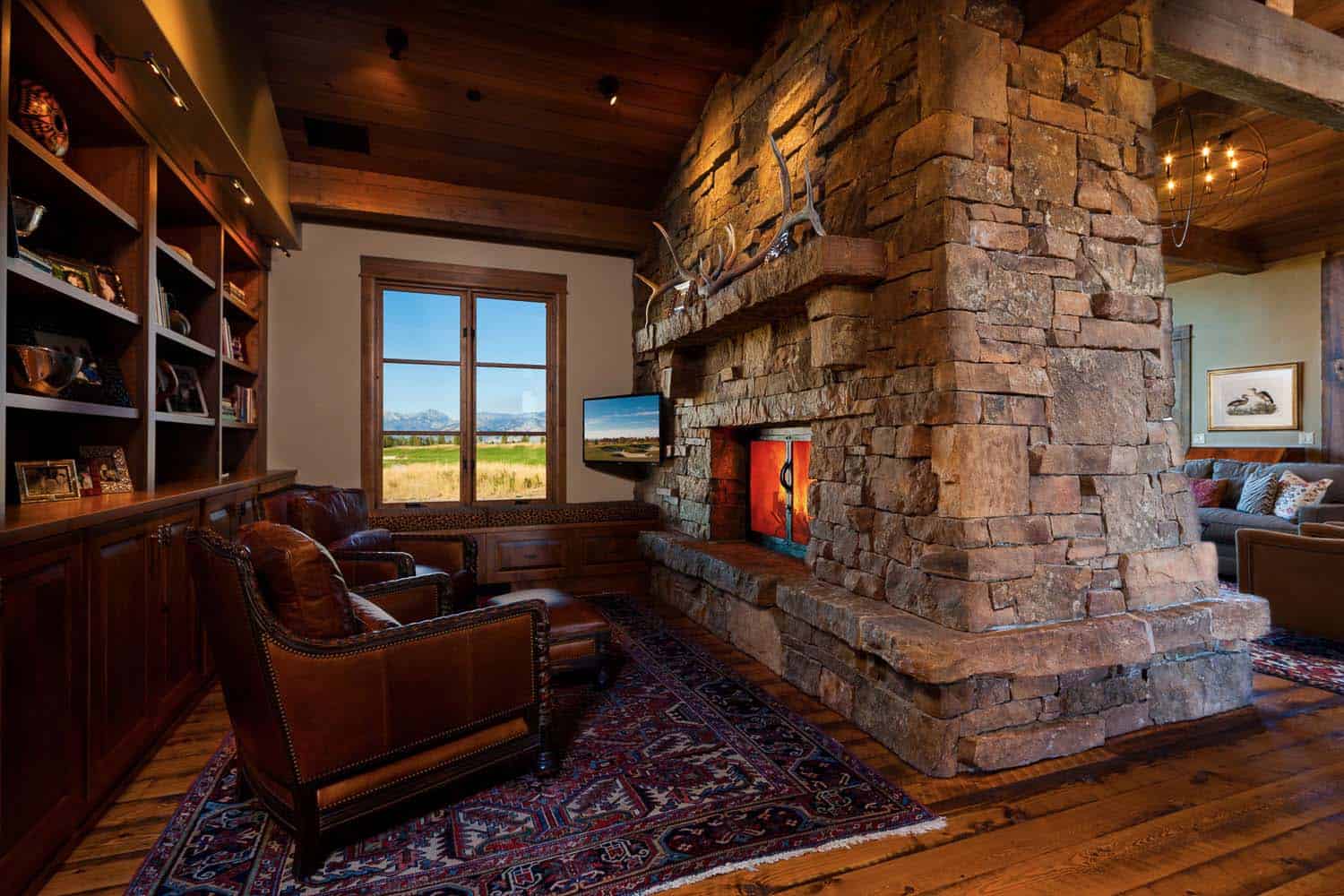 rustic reading nook with a stone fireplace