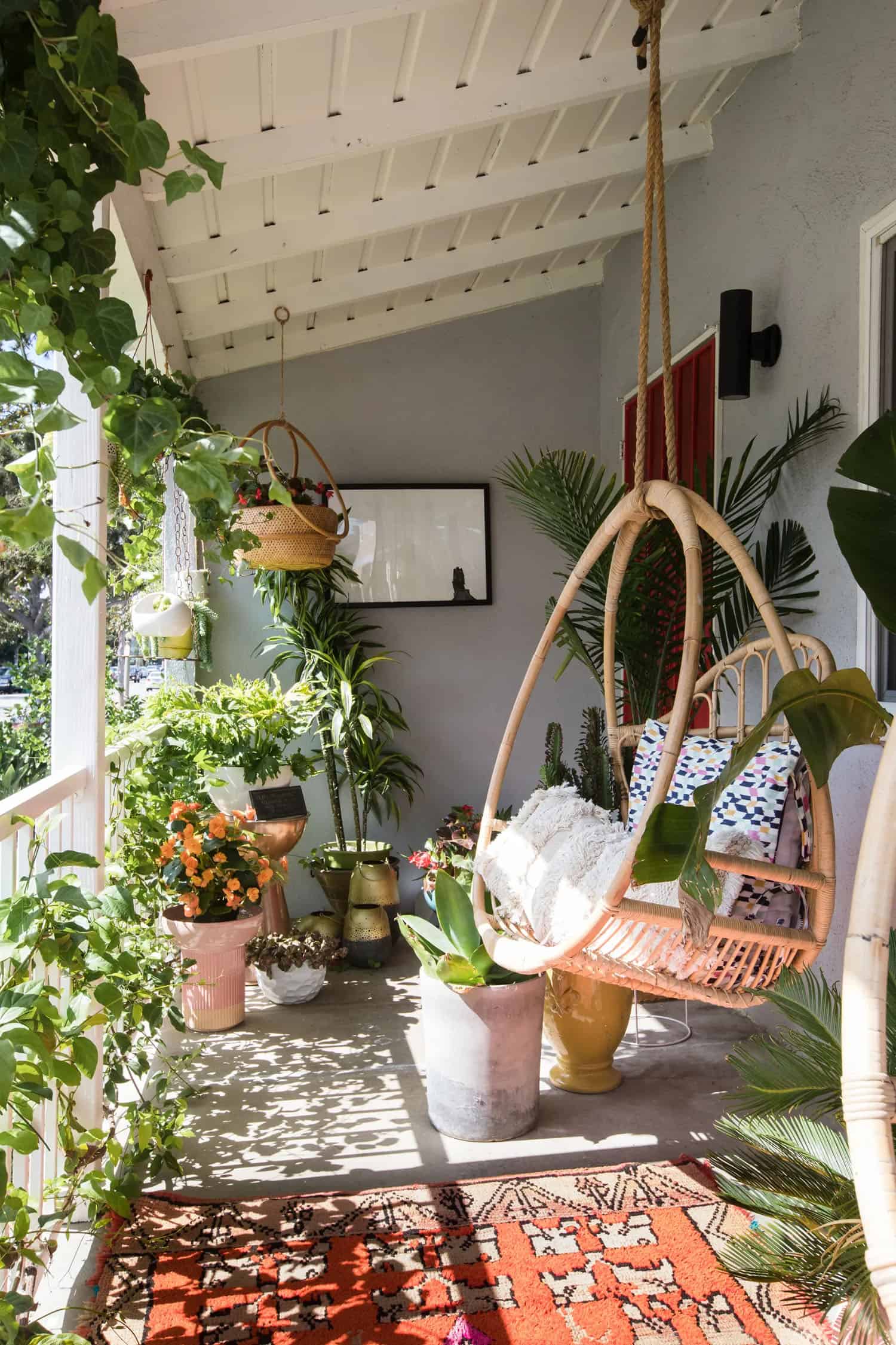 cozy-porch-with-a-hanging-swing-and-plants