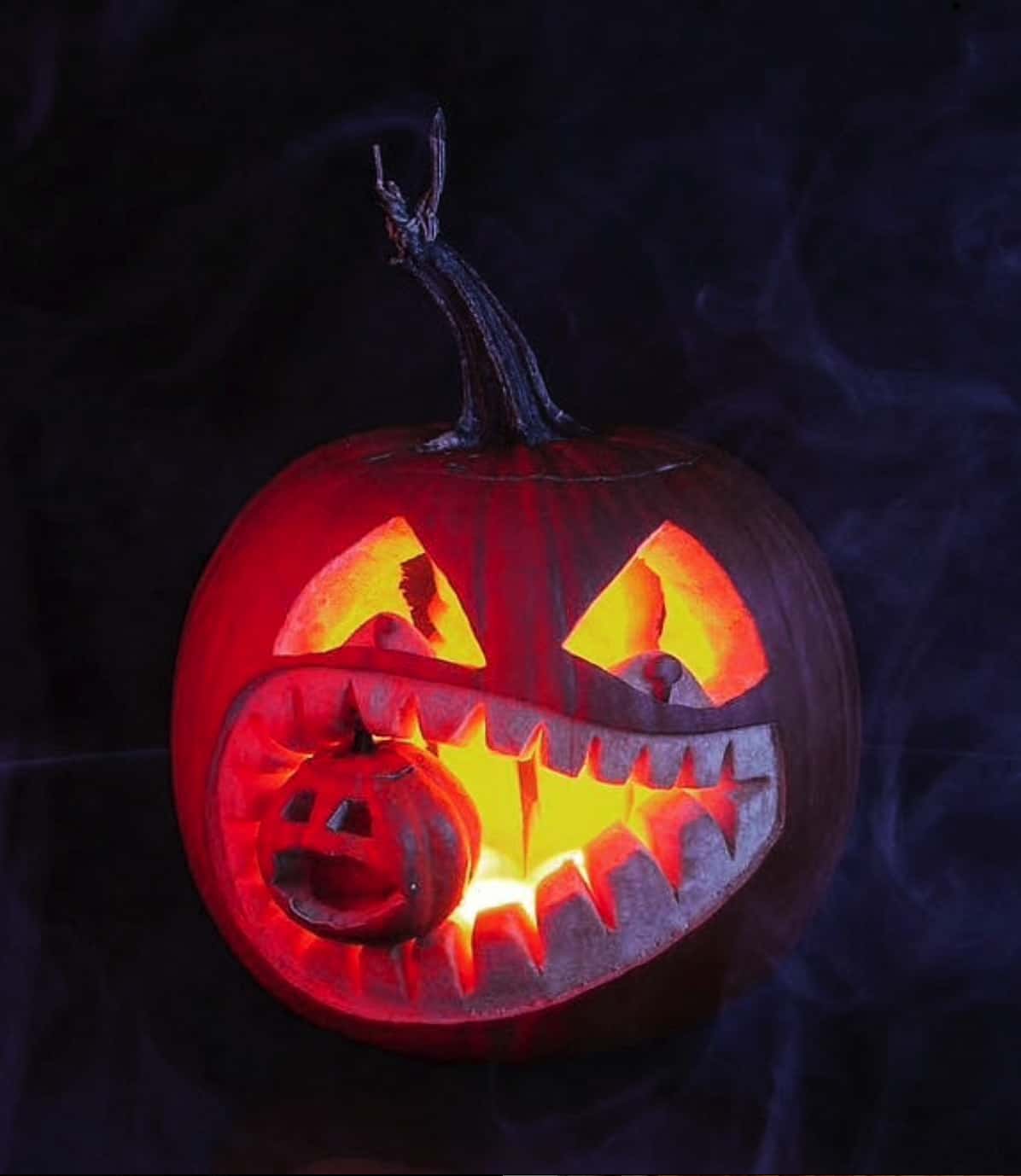 spooky-pumpkin-monster-with-a-baby-pumpkin-in-its-teeth