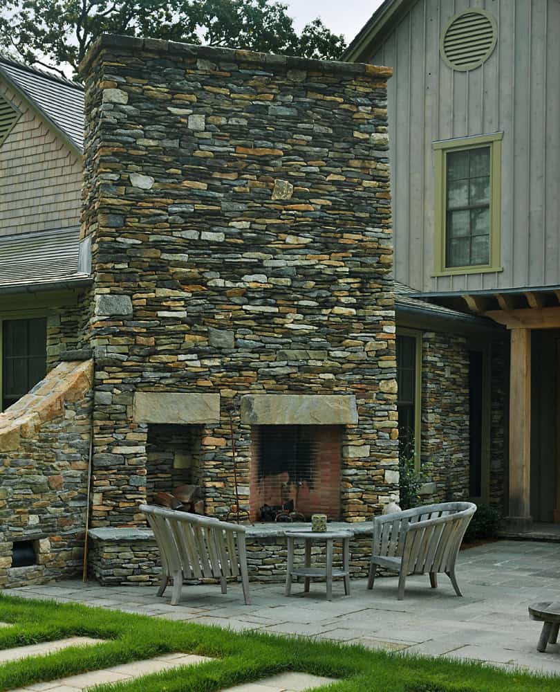 beach-style-bedroom-with-an-outdoor-stone-fireplace