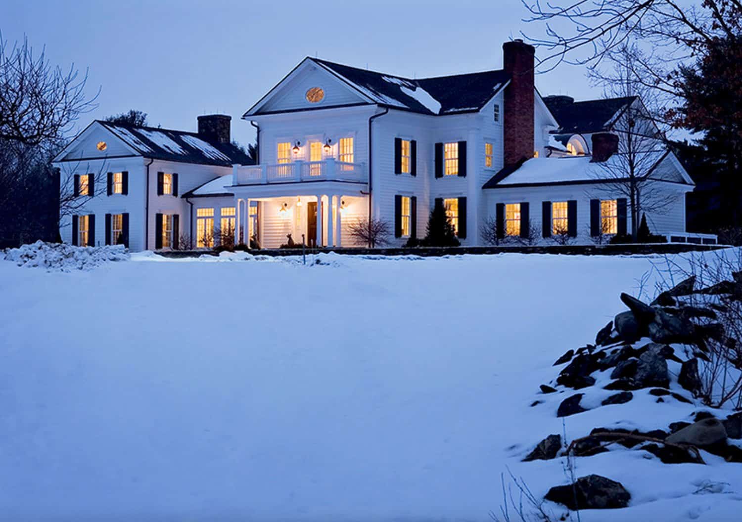 traditional-home-exterior-with-snow-at-dusk