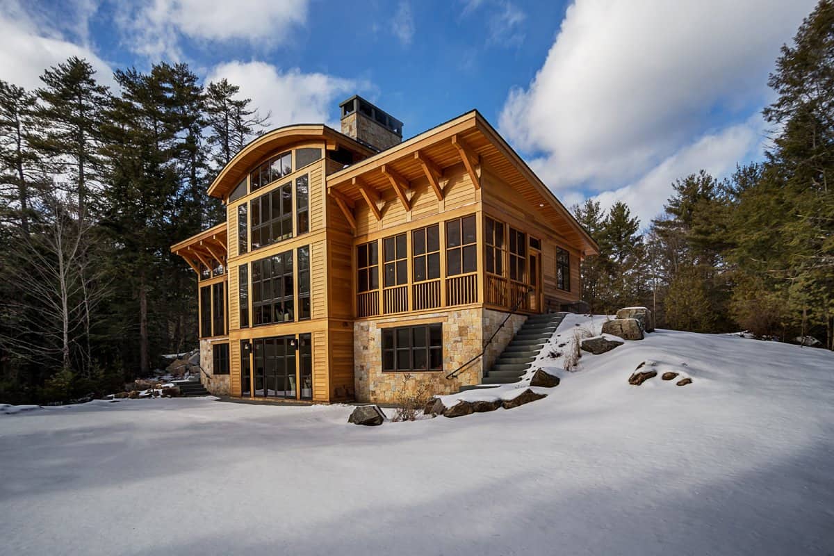 hilltop-lake-house-exterior-with-snow