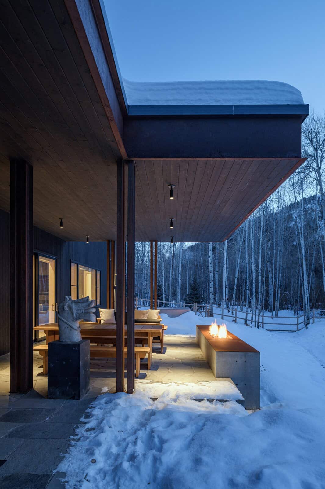 modern-barn-style-home-exterior-with-snow-dusk-sun-valley