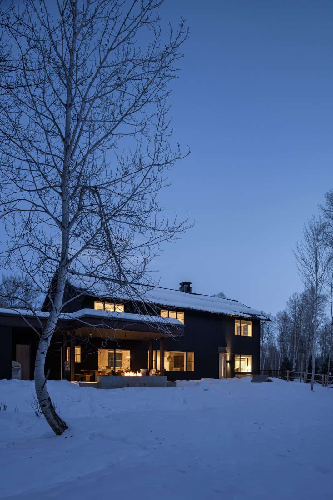 modern-barn-style-home-exterior-with-snow-sun-valley-dusk