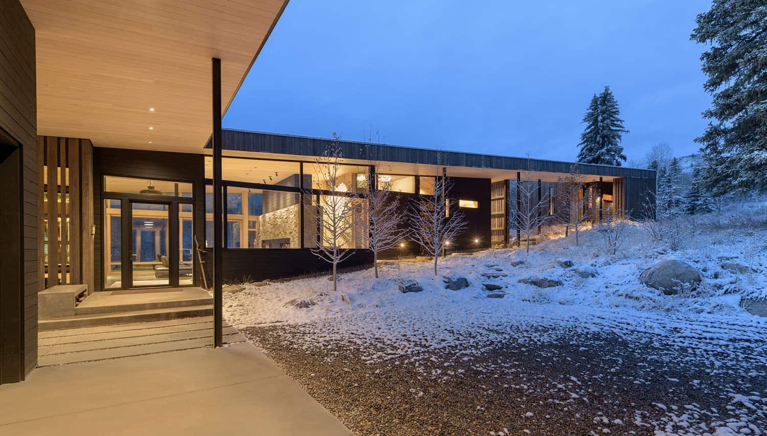 mountain-modern-home-exterior-with-snow-at-dusk