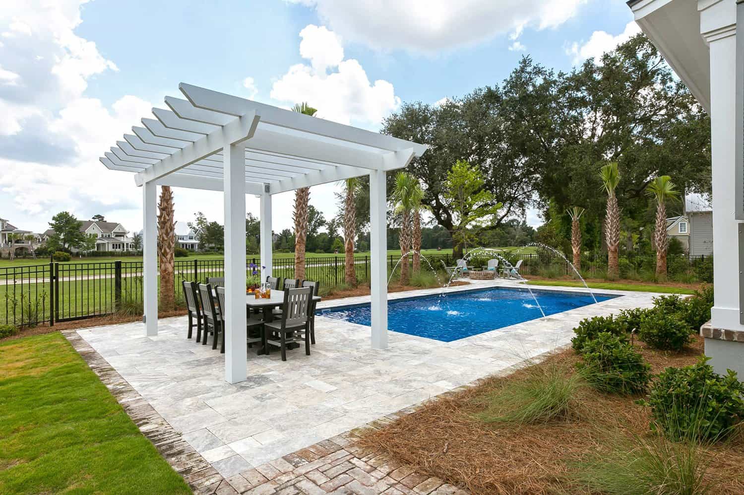 beach-style-patio-with-a-pool-and-trellis