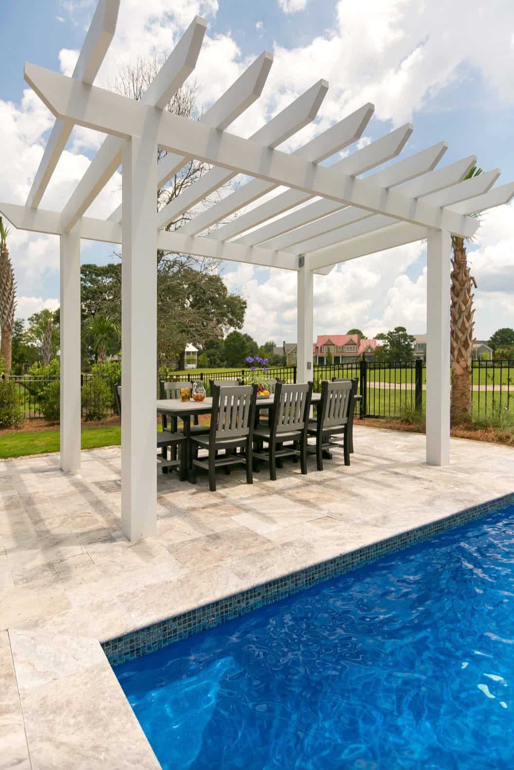 beach-style-patio-with-a-pool-and-trellis