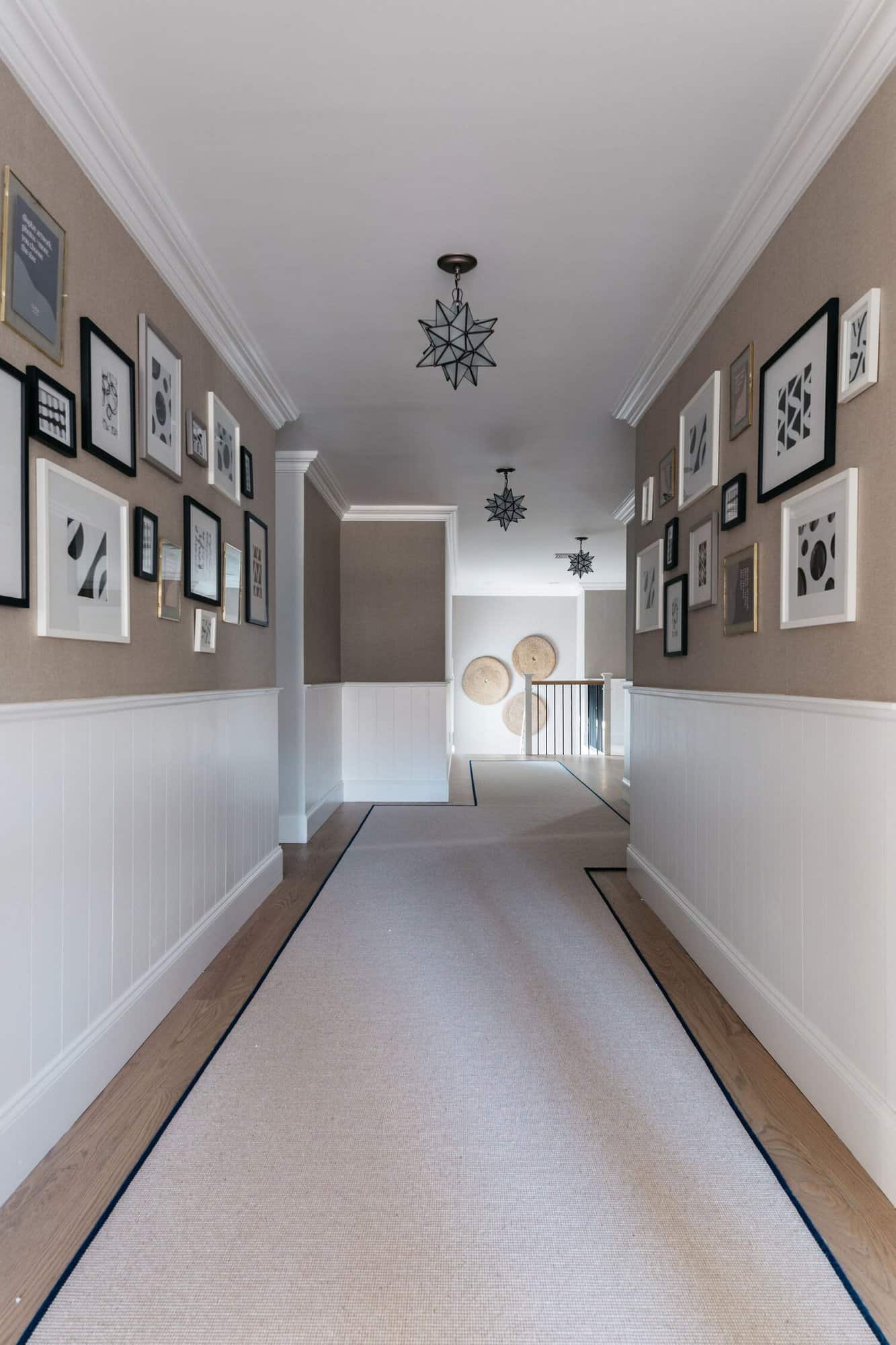beach-style-upstairs-hallway-with-art-gallery-walls
