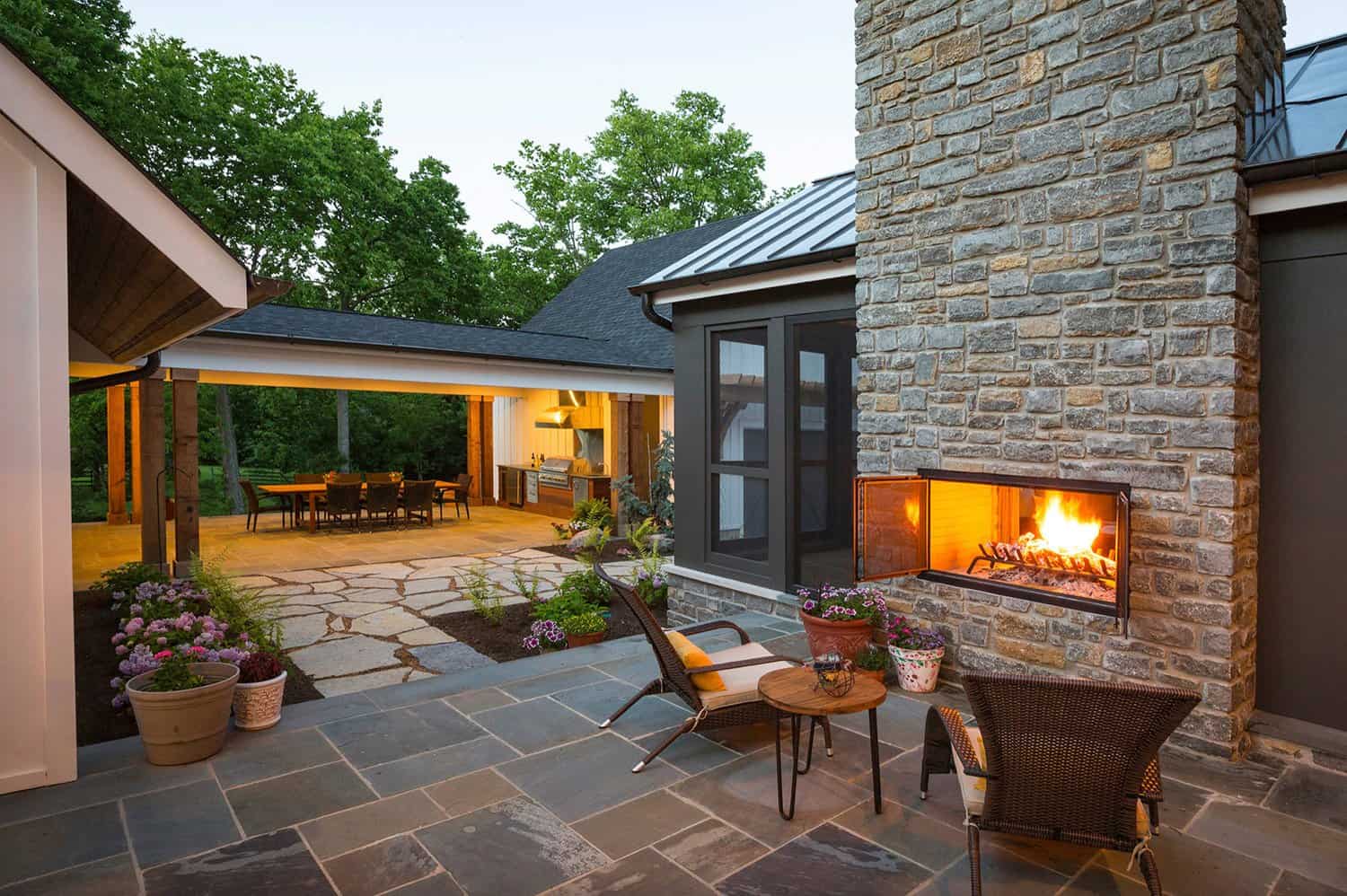 farmhouse-style-patio-with-fireplace-dusk