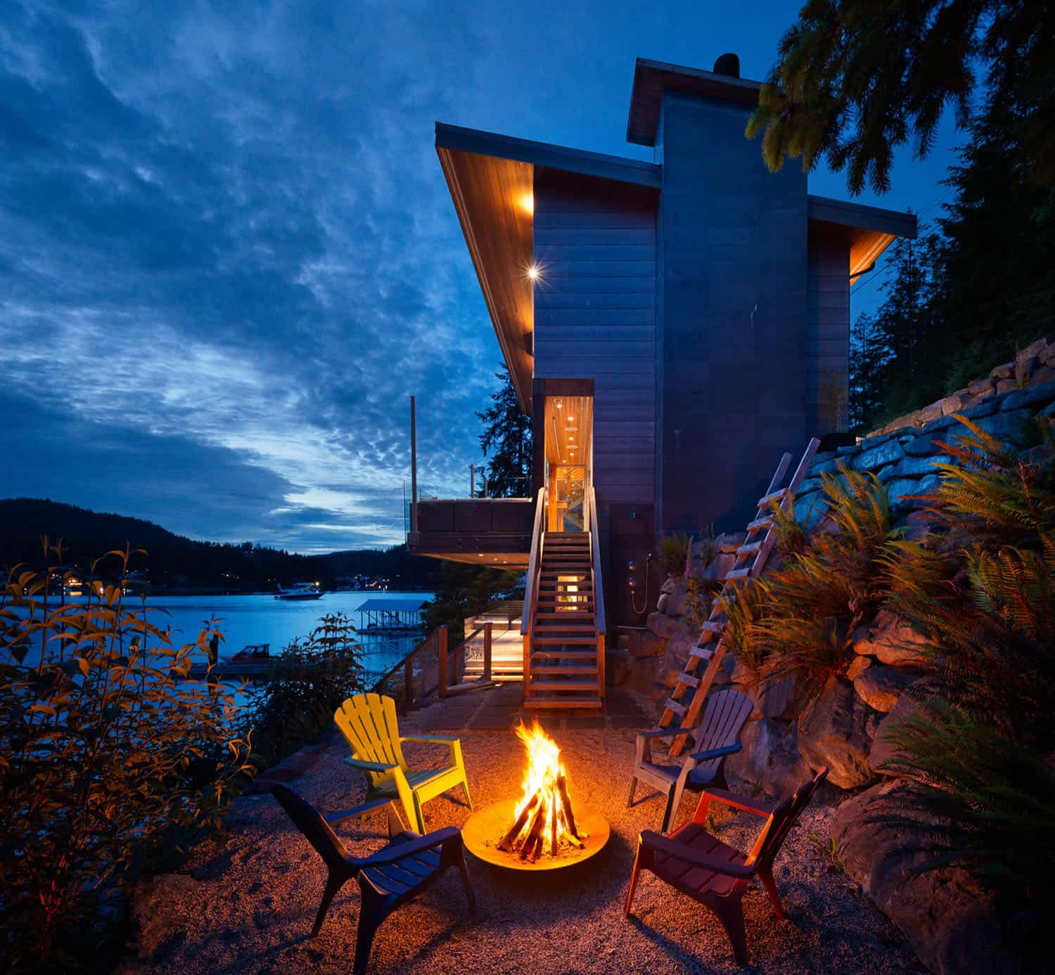 modern-waterfront-home-exterior-fire-pit-at-dusk