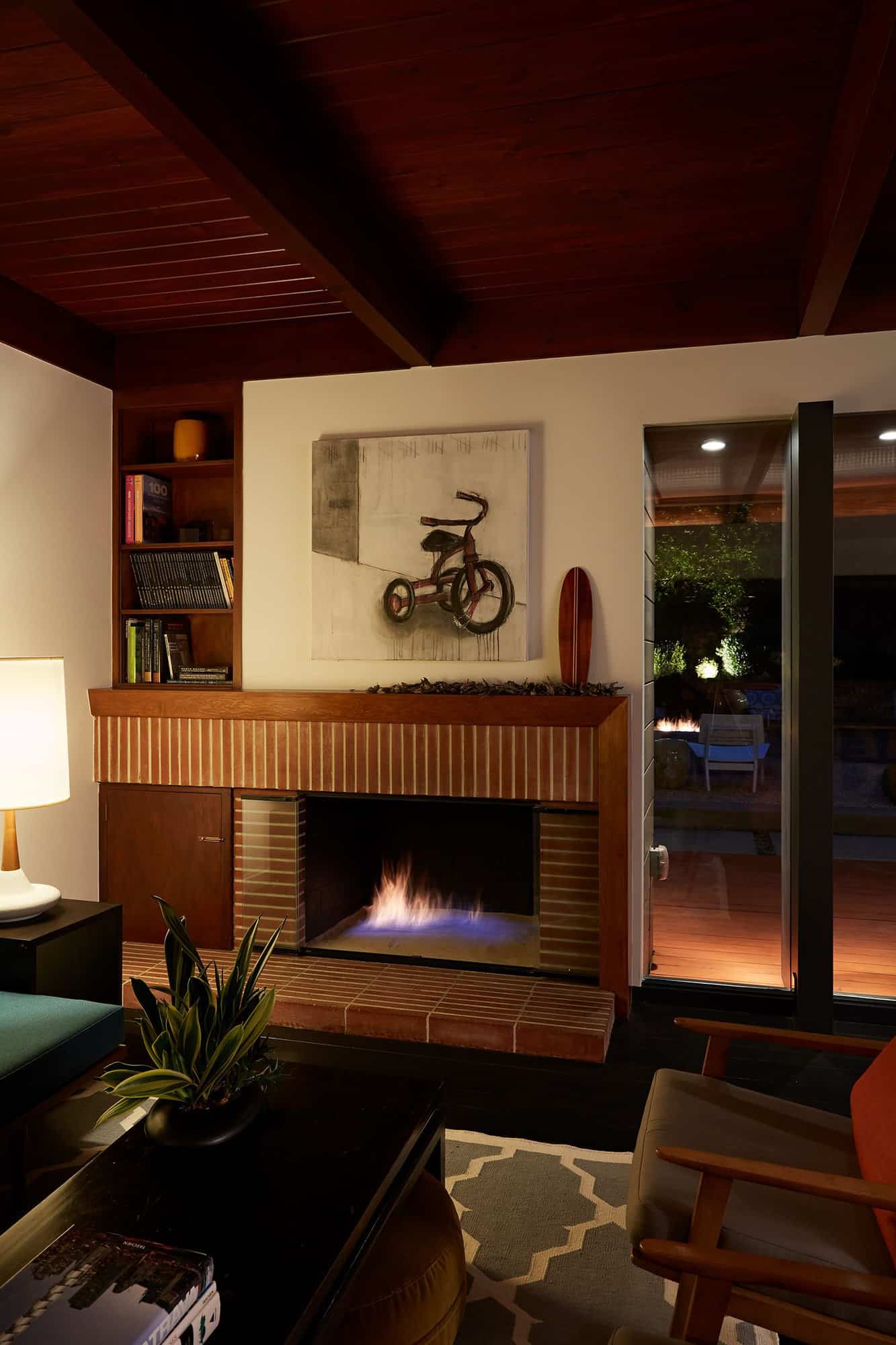 mid-century-modern-living-room-with-a-fireplace-at-dusk