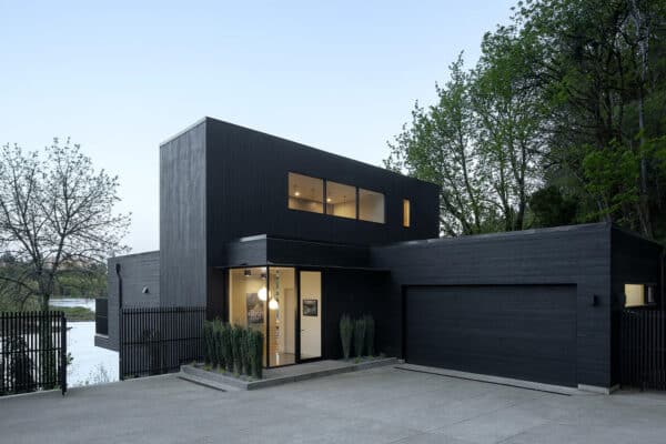 featured posts image for A blackened cedar house cantilevers over the tranquil Willamette River