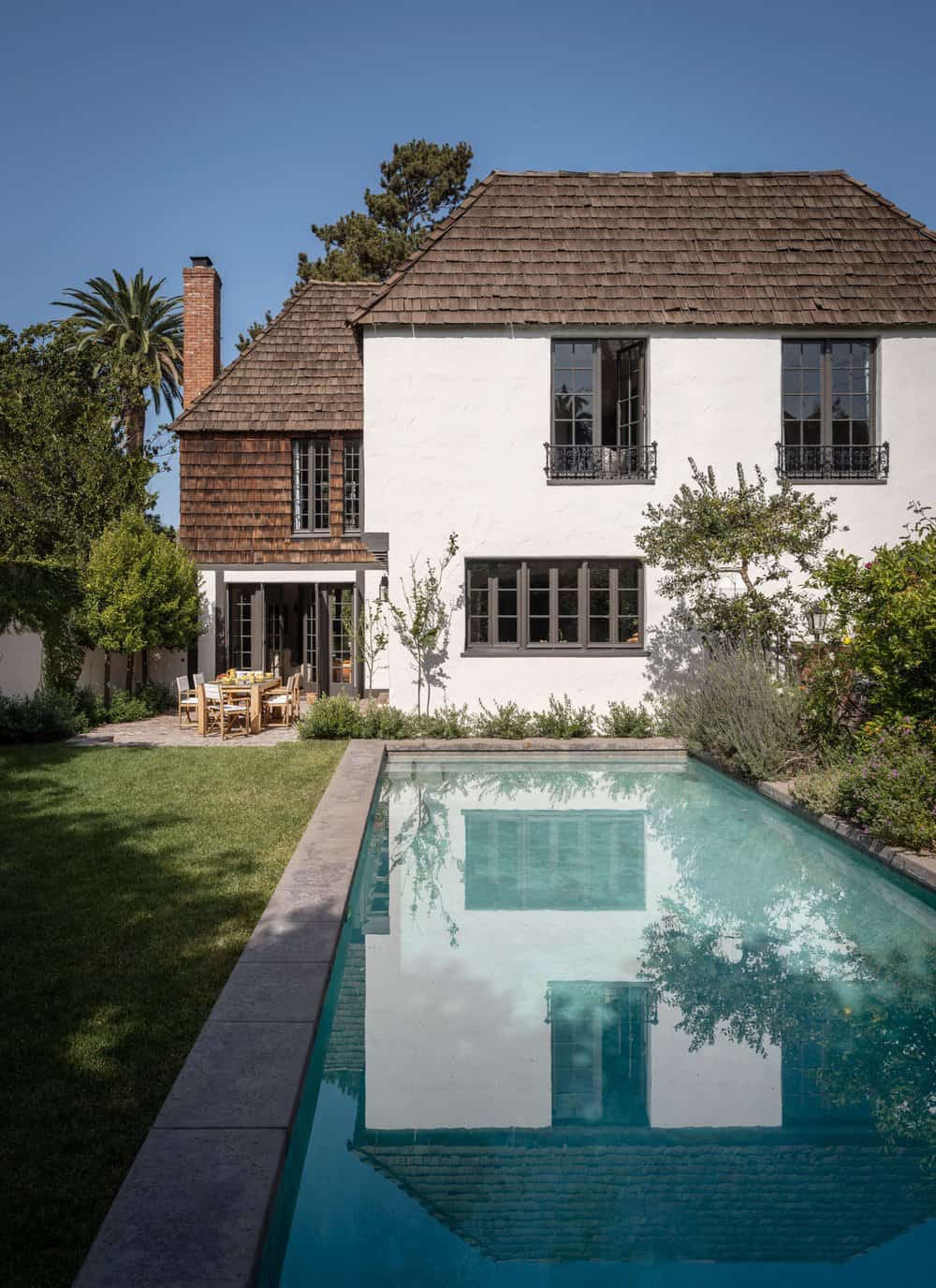 french-eclectic-home-exterior-with-a-swimming-pool