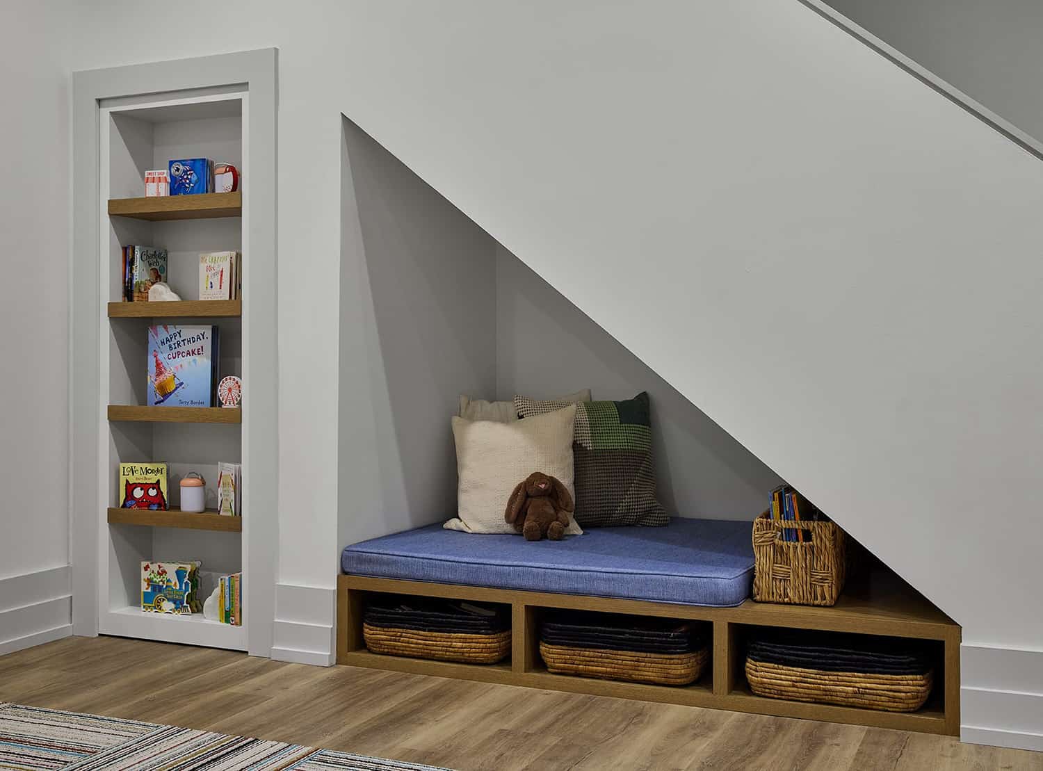 contemporary-basement-reading-nook-tucked-under-the-staircase-with-a-secret-door-leading-to-a-play-room