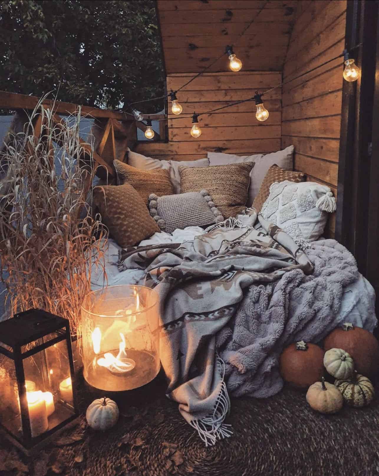 outdoor-porch-with-a-daybed-decorated-for-fall