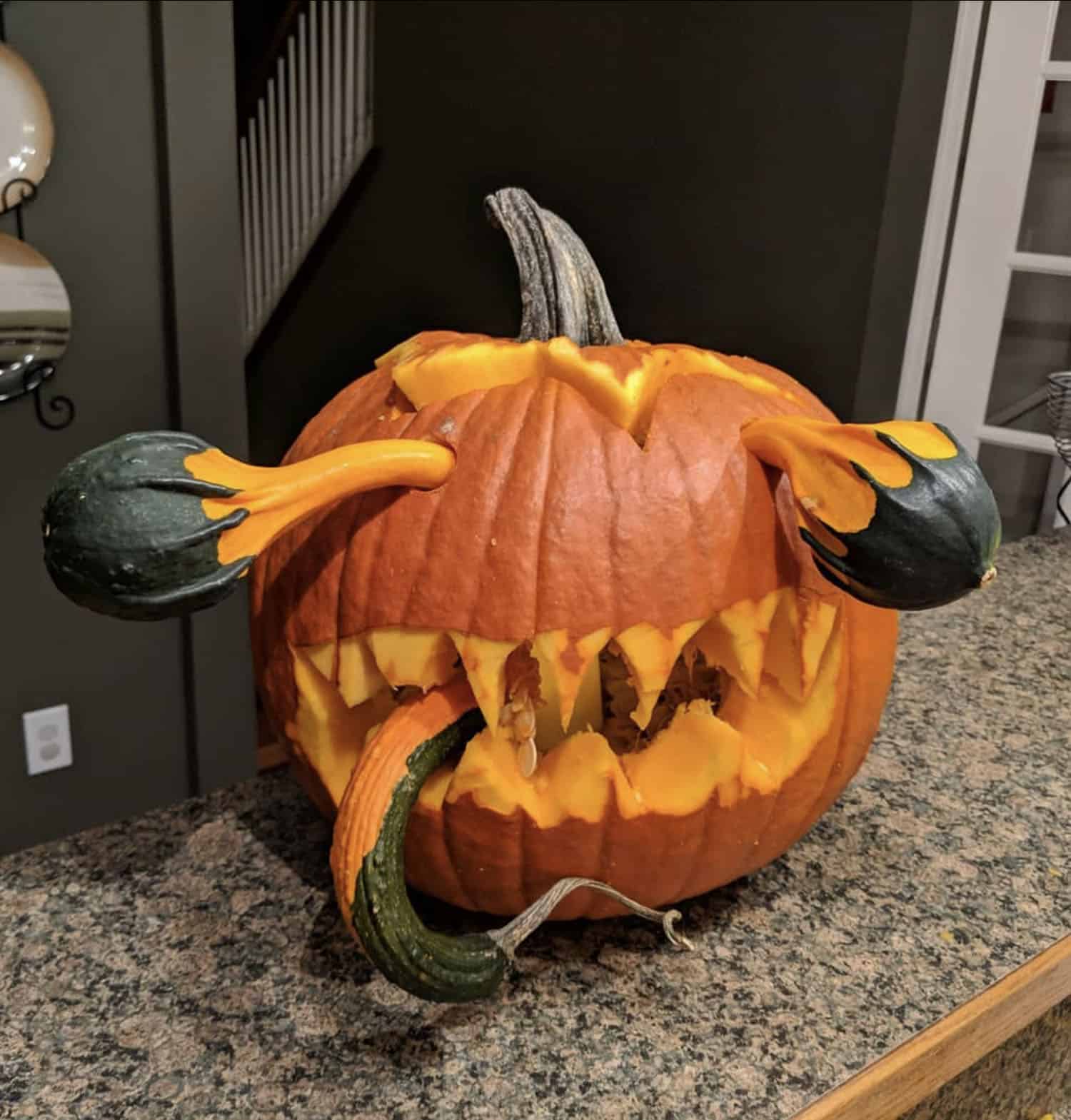 carved-pumpkin-with-teeth-and-gourds