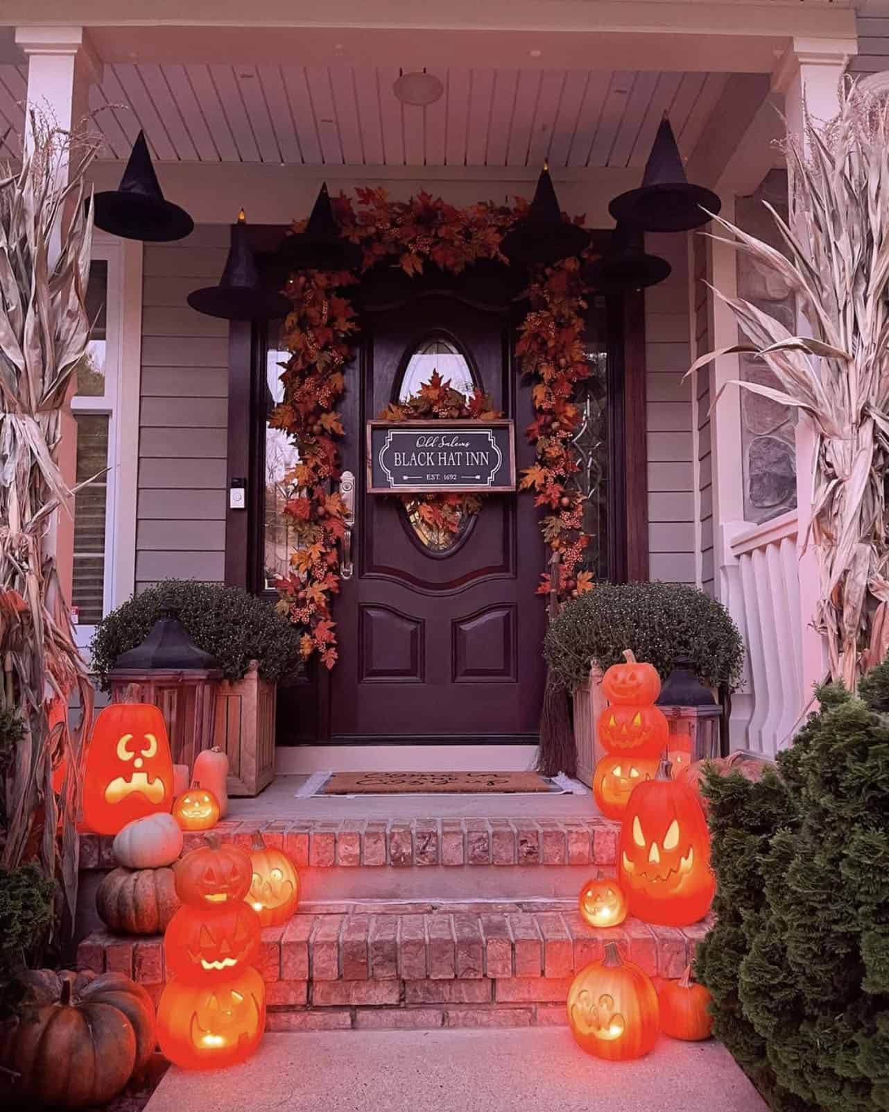 halloween-decorated-front-door-with-lighted-pumpkins-and-witch-hats