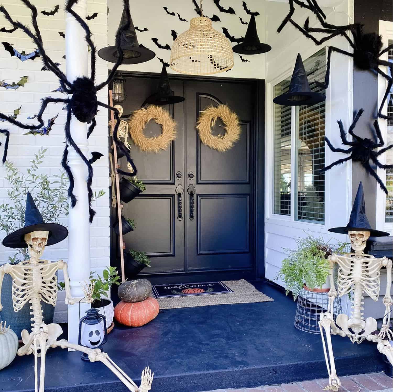 halloween-front-porch-decor-with-skeletons-spiders-and-witch-hats
