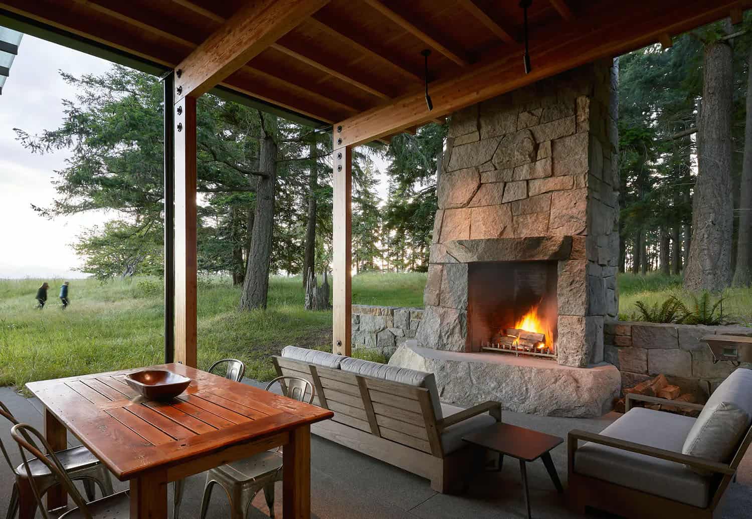 modern-covered-porch-with-a-fireplace