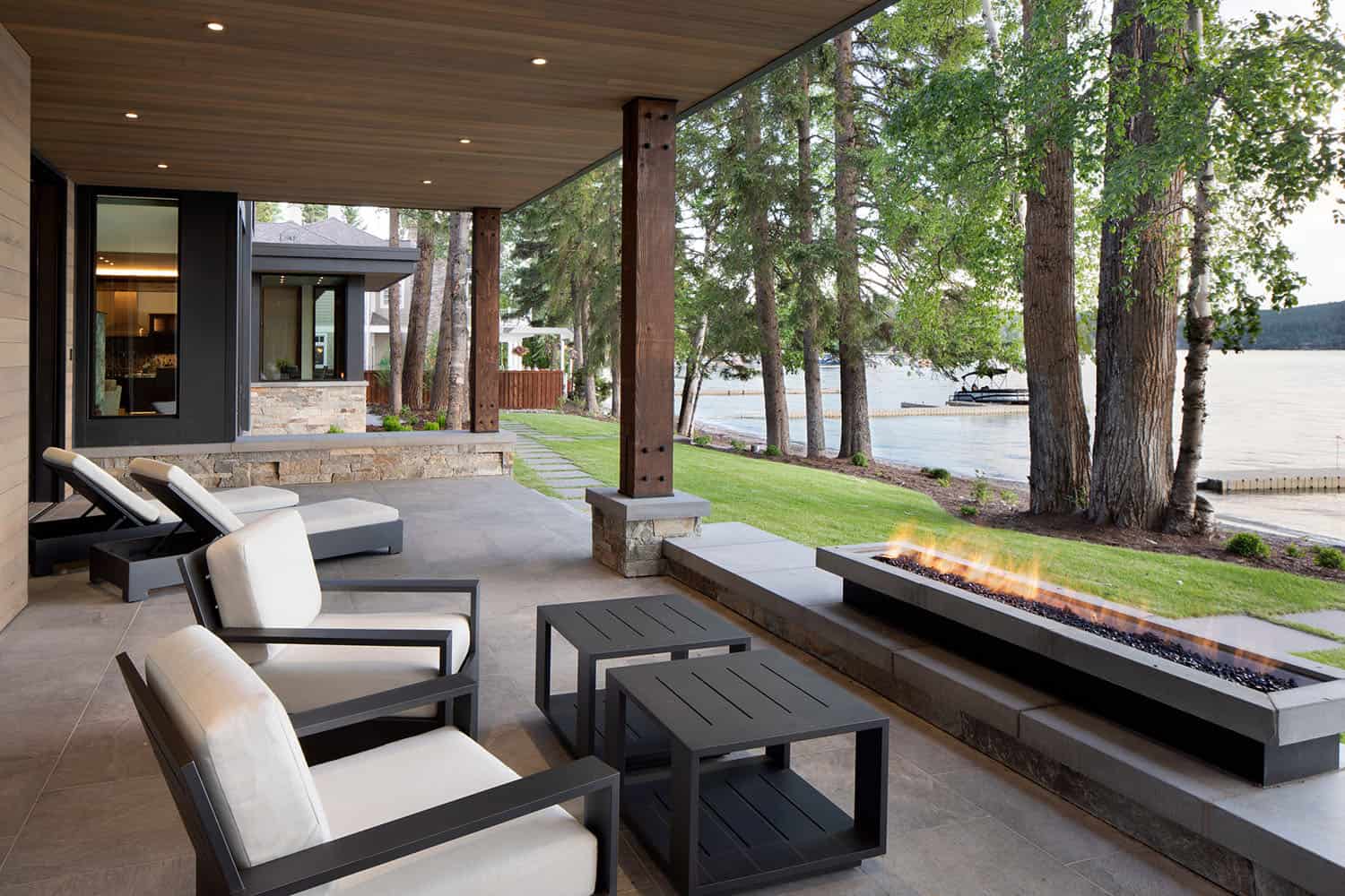 modern-outdoor-patio-with-a-fire-pit-looking-towards-whitefish-lake