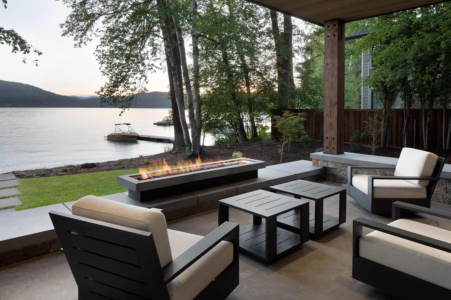 modern-outdoor-patio-with-a-fire-pit-looking-towards-whitefish-lake