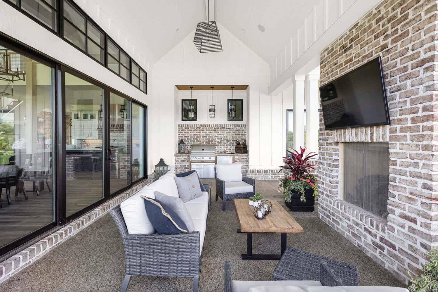 modern-farmhouse-covered-porch-with-a-brick-fireplace
