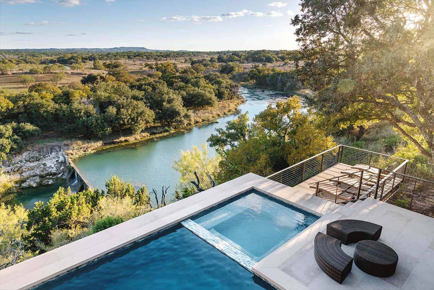 A modern ranch house in the Texas Hill Country floats over a rocky cliff