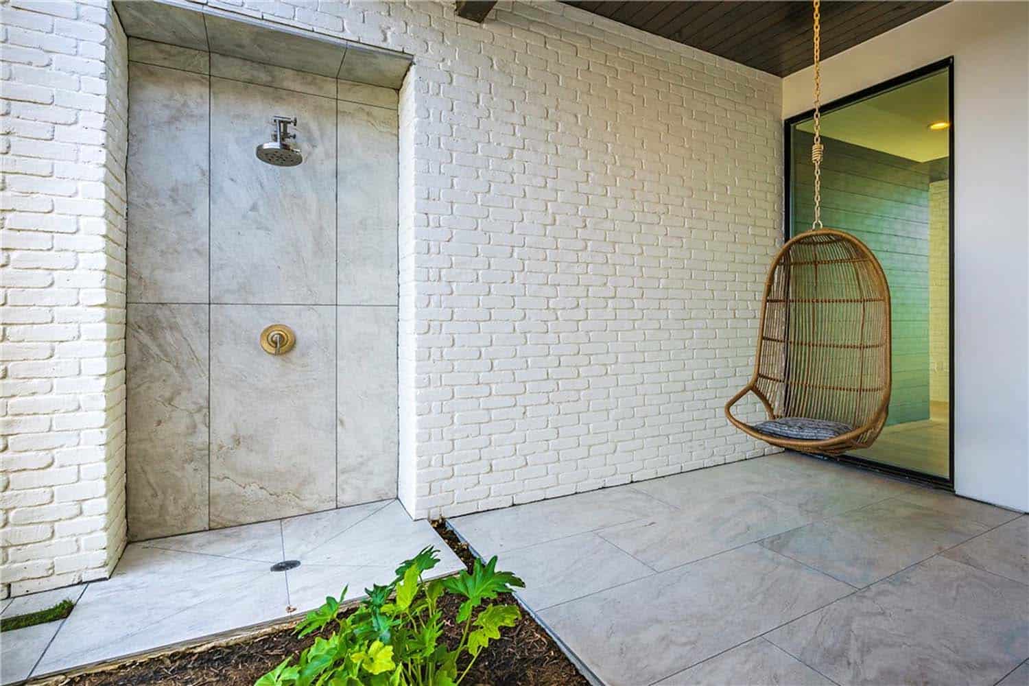 contemporary-farmhouse-porch-with-outdoor-shower-and-hanging-chairs