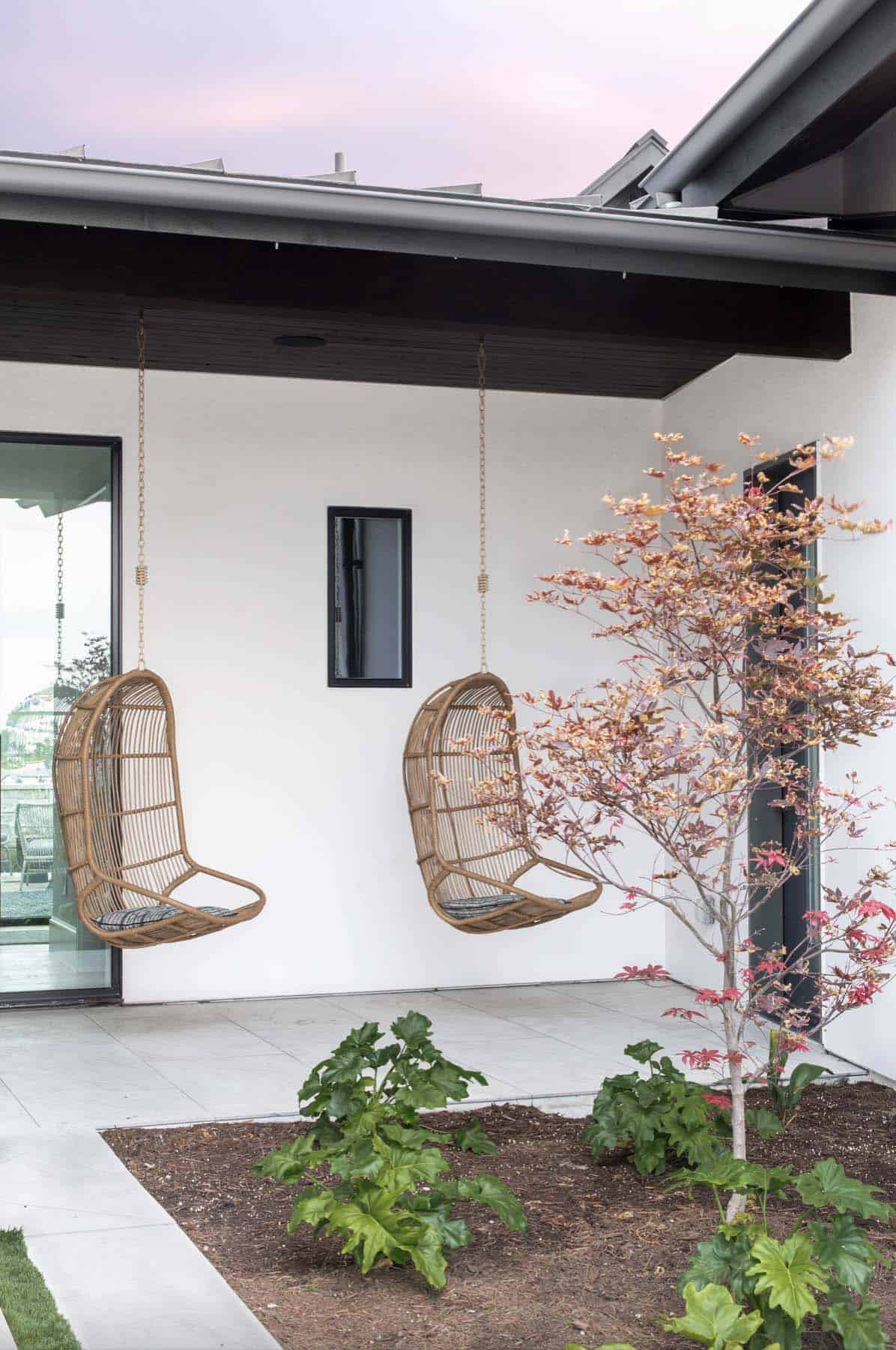 contemporary-farmhouse-front-porch-with-hanging-chairs