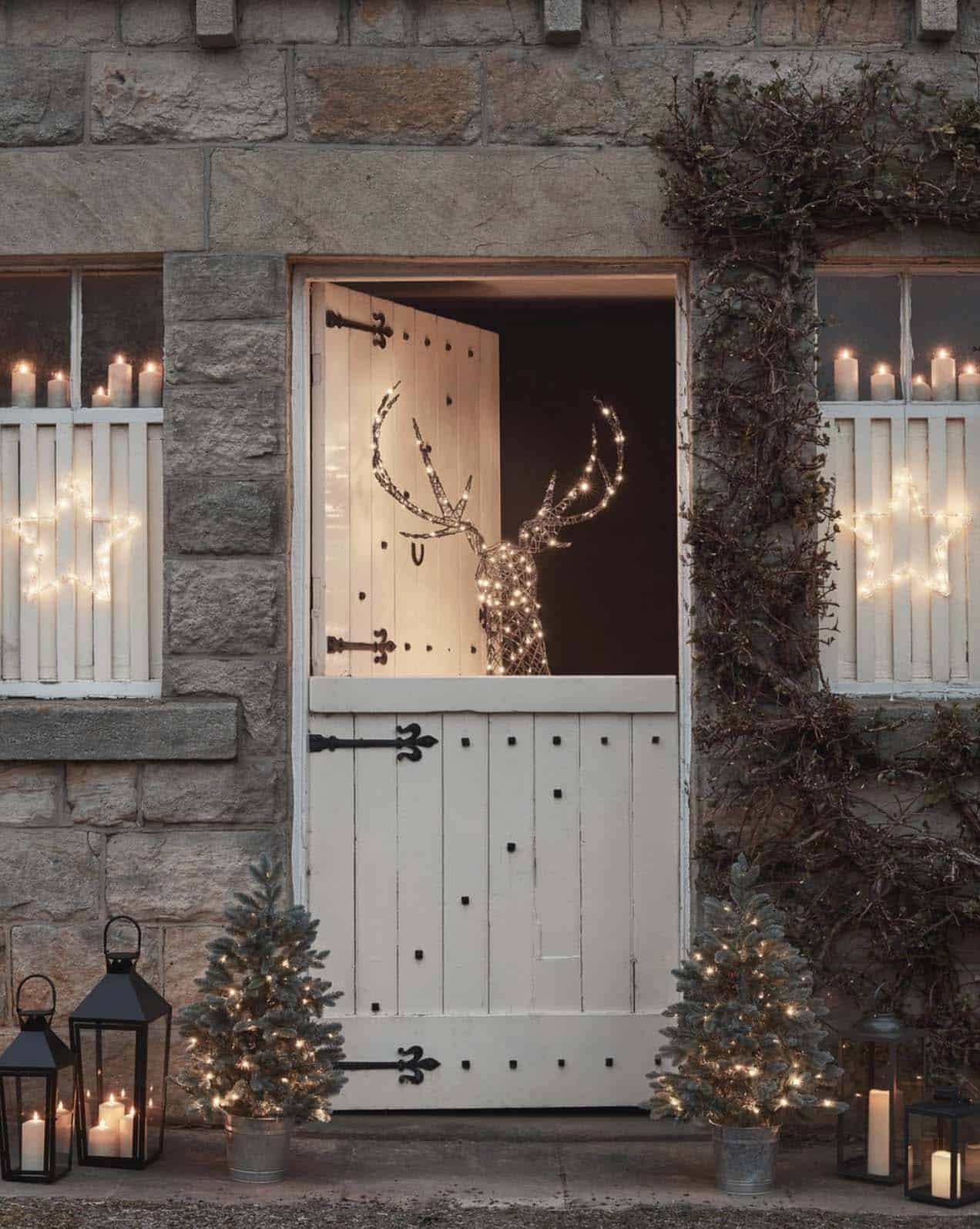 lighted-reindeer-behind-a-dutch-door-and-small-christmas-trees