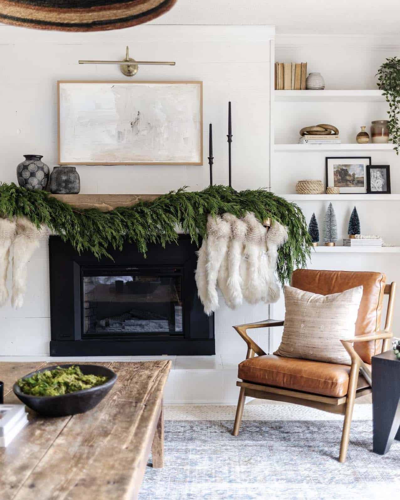fresh-cypress-garland-on-the-fireplace-mantel-with-stockings