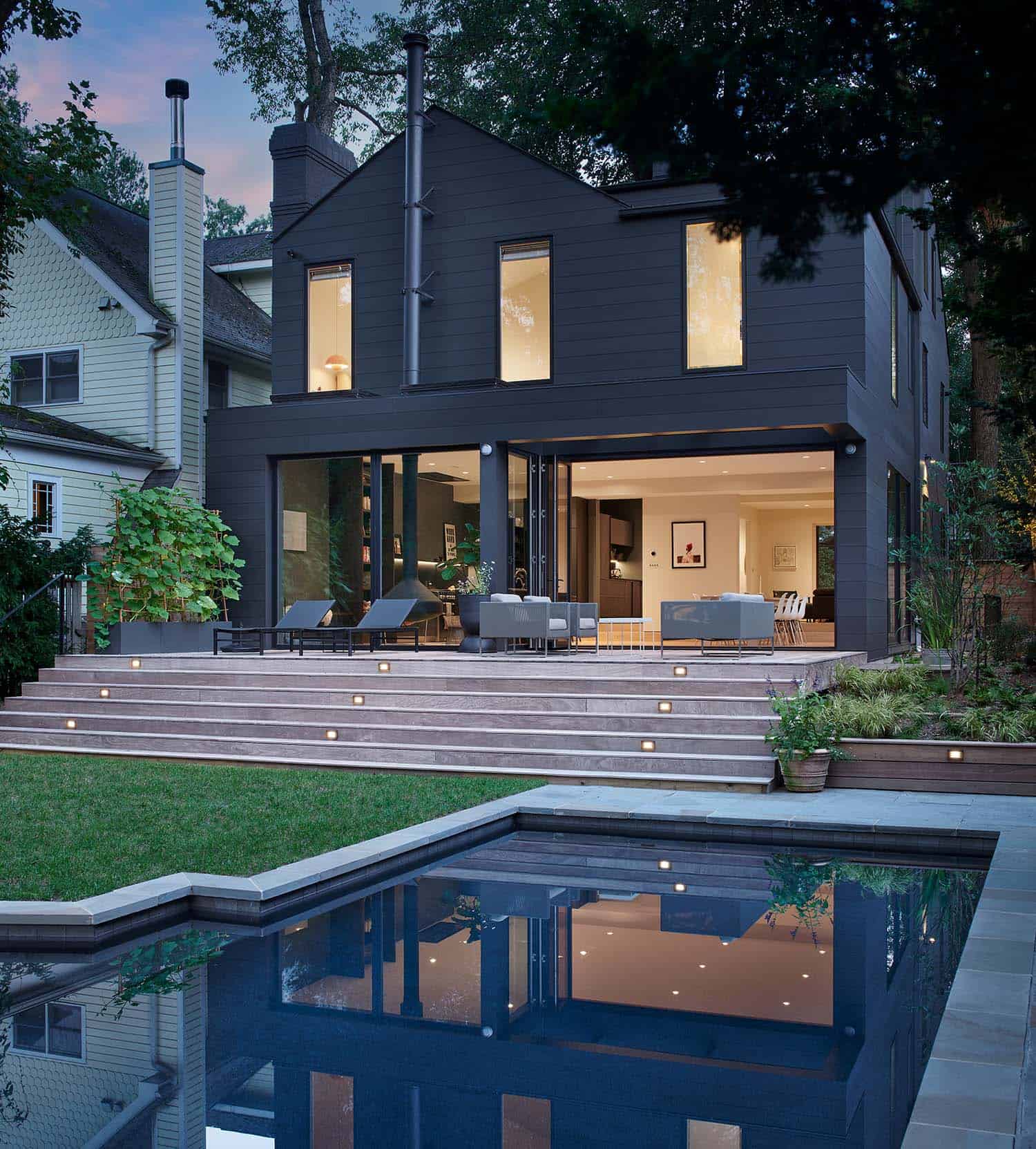 modern-craftsman-home-exterior-with-a-pool-at-dusk