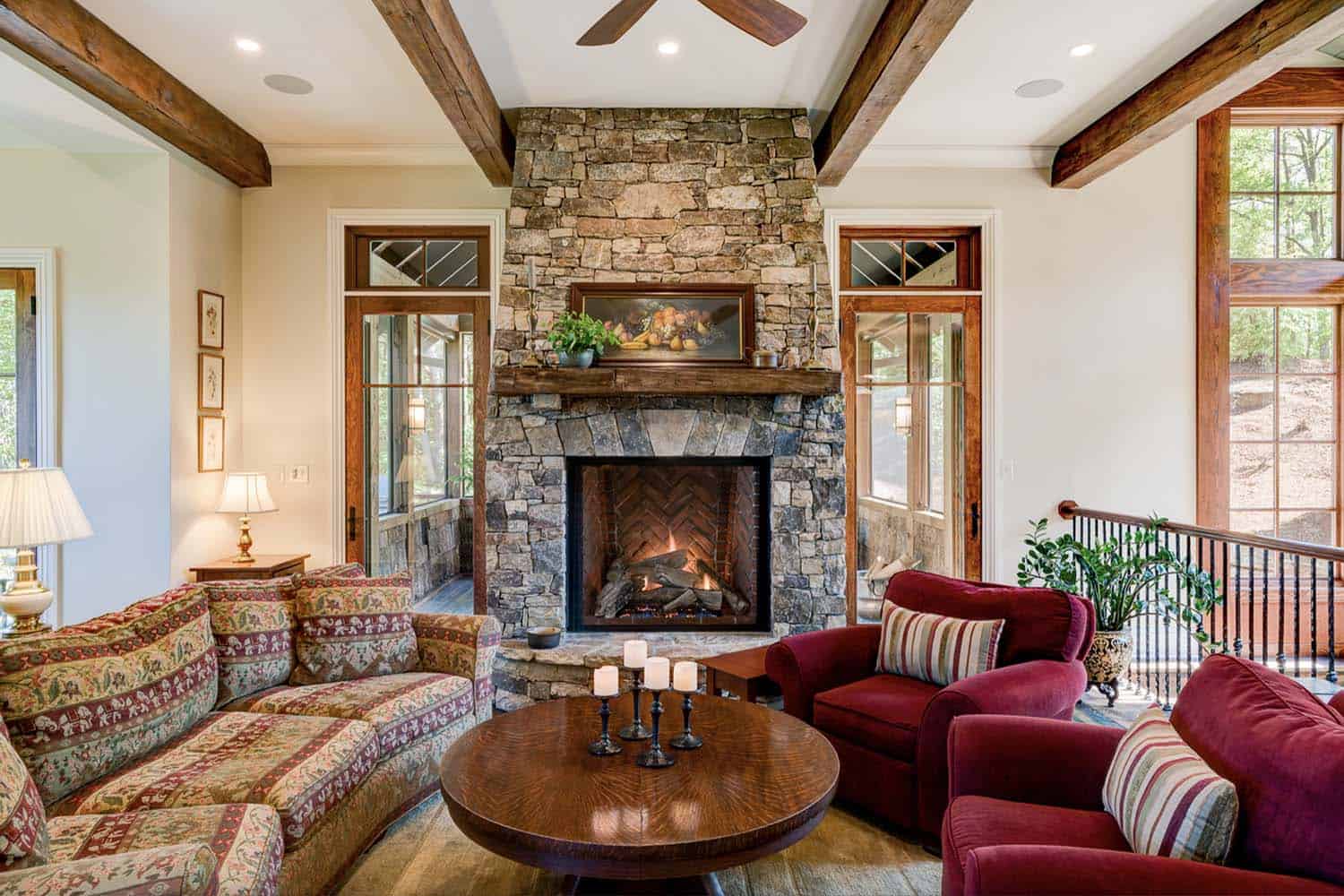 stone-fireplace-den-with-open-staircase-to-basement