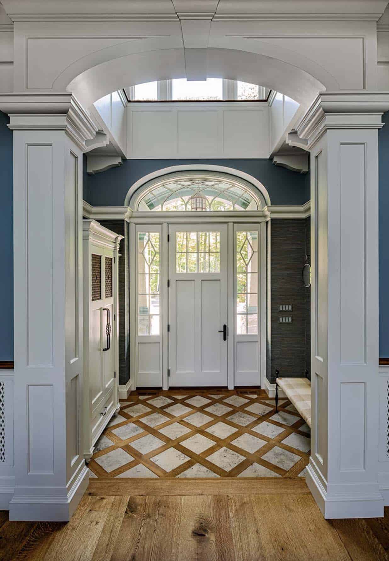 grand-home-entryway-with-tile-and-wood-flooring