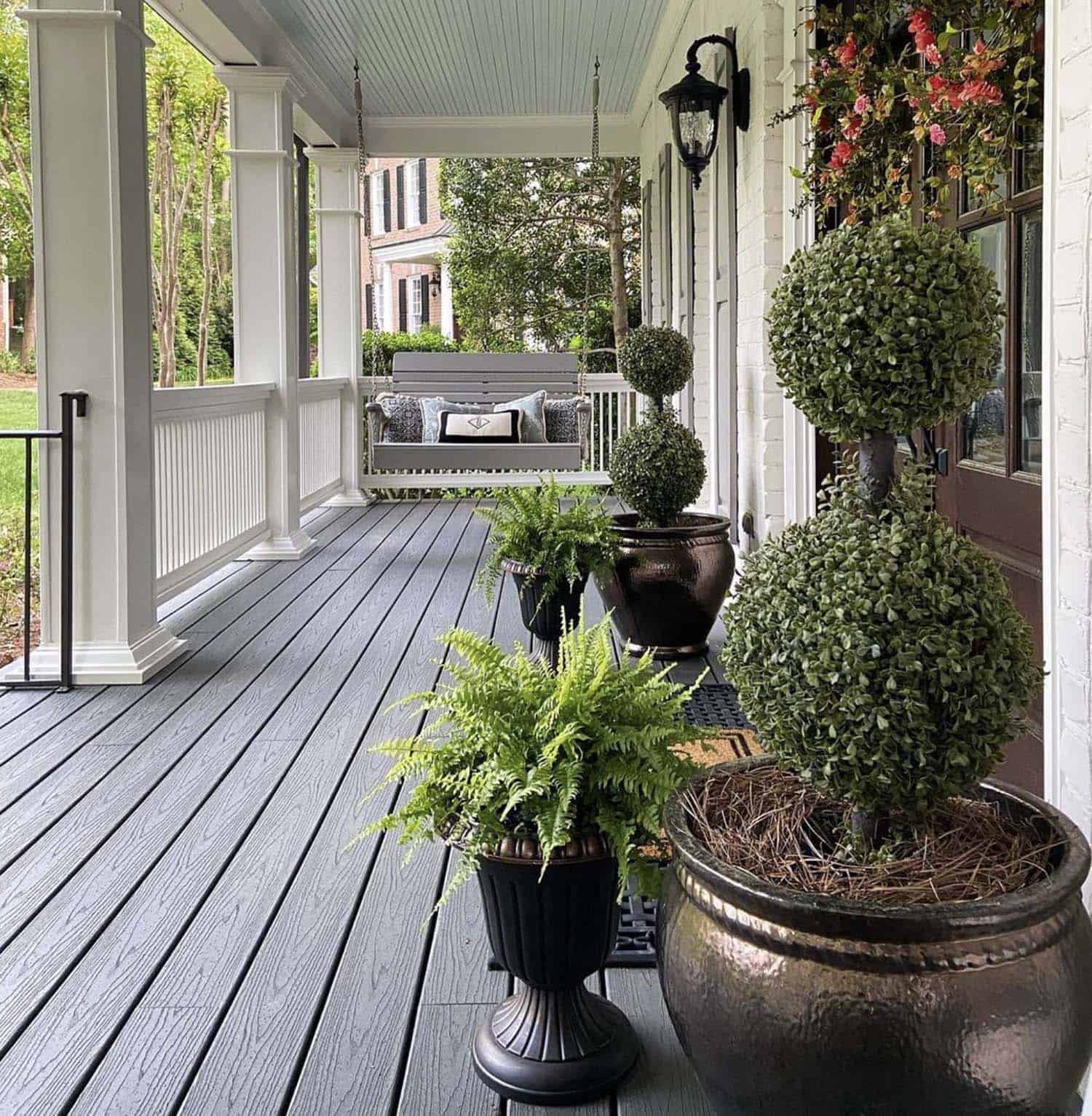 spring-front-porch-with-boxwood-topiaries-and-porch-swing