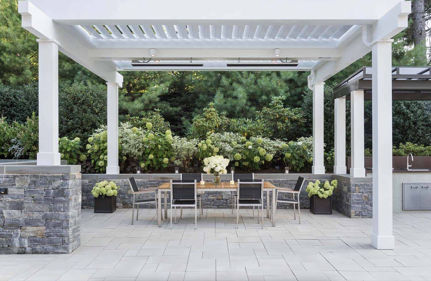 patio-pergola-design-with-lush-plants-backdrop