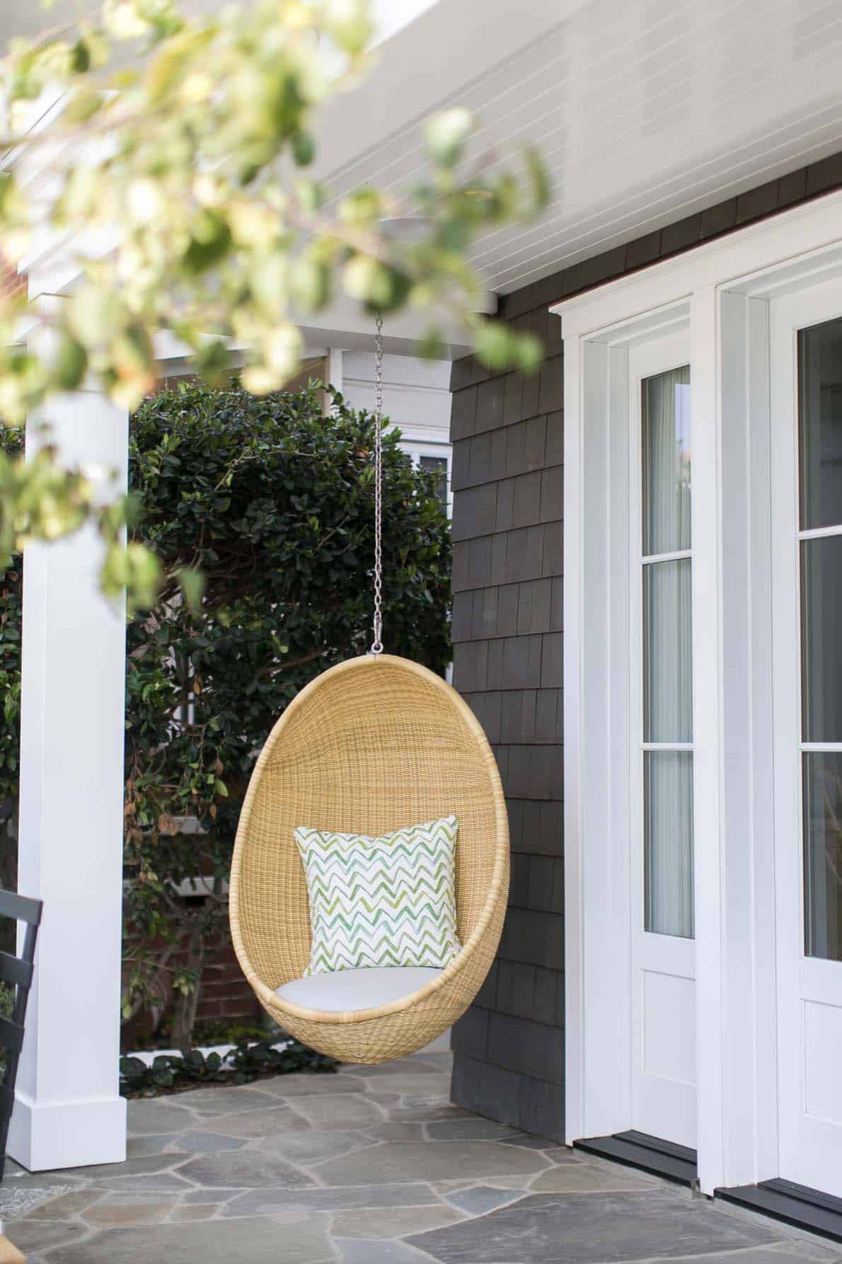 beach-style-home-patio-with-a-hanging-chair