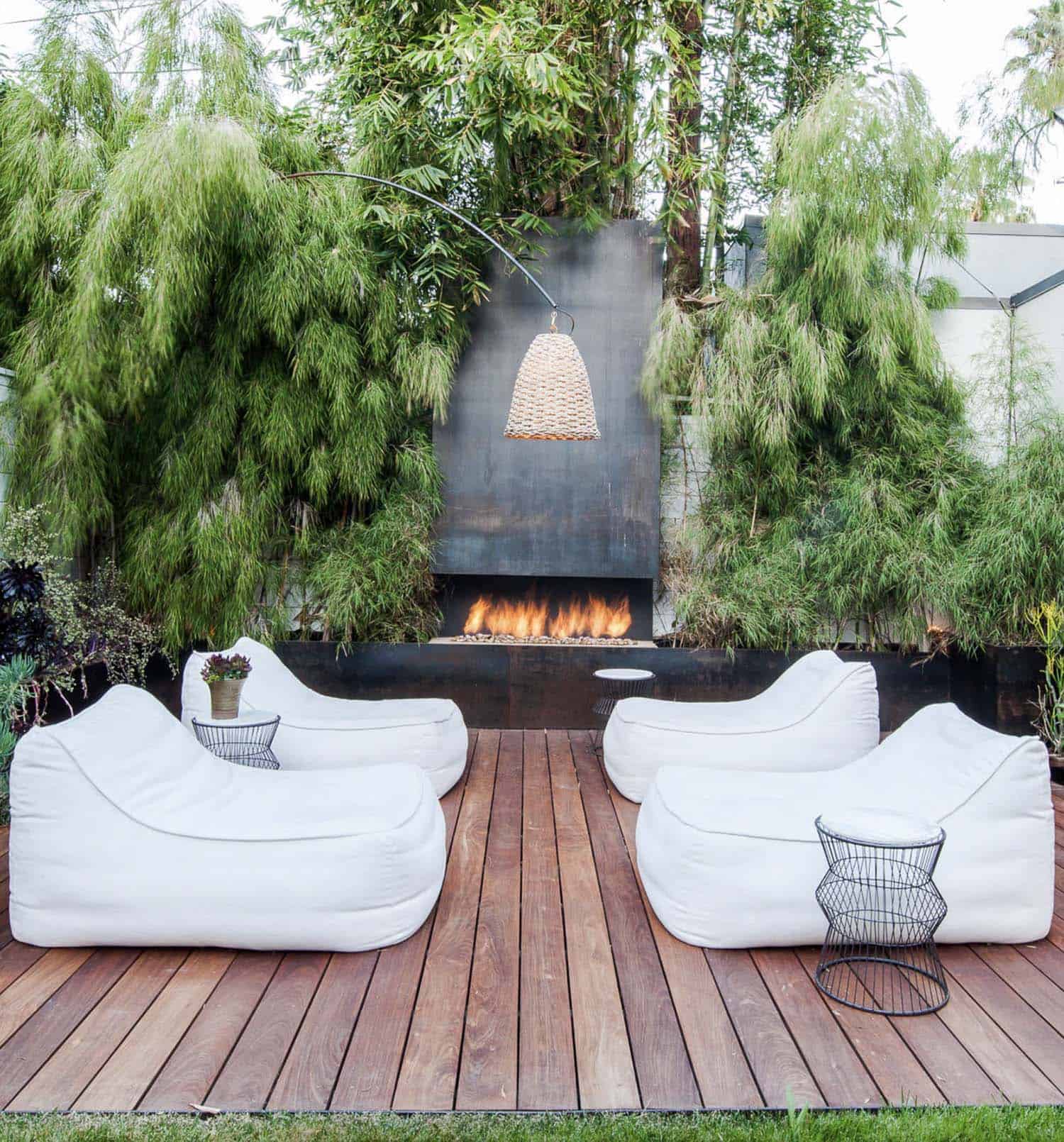 backyard-deck-with-a-fireplace-and-bean-bag-lounge-chairs