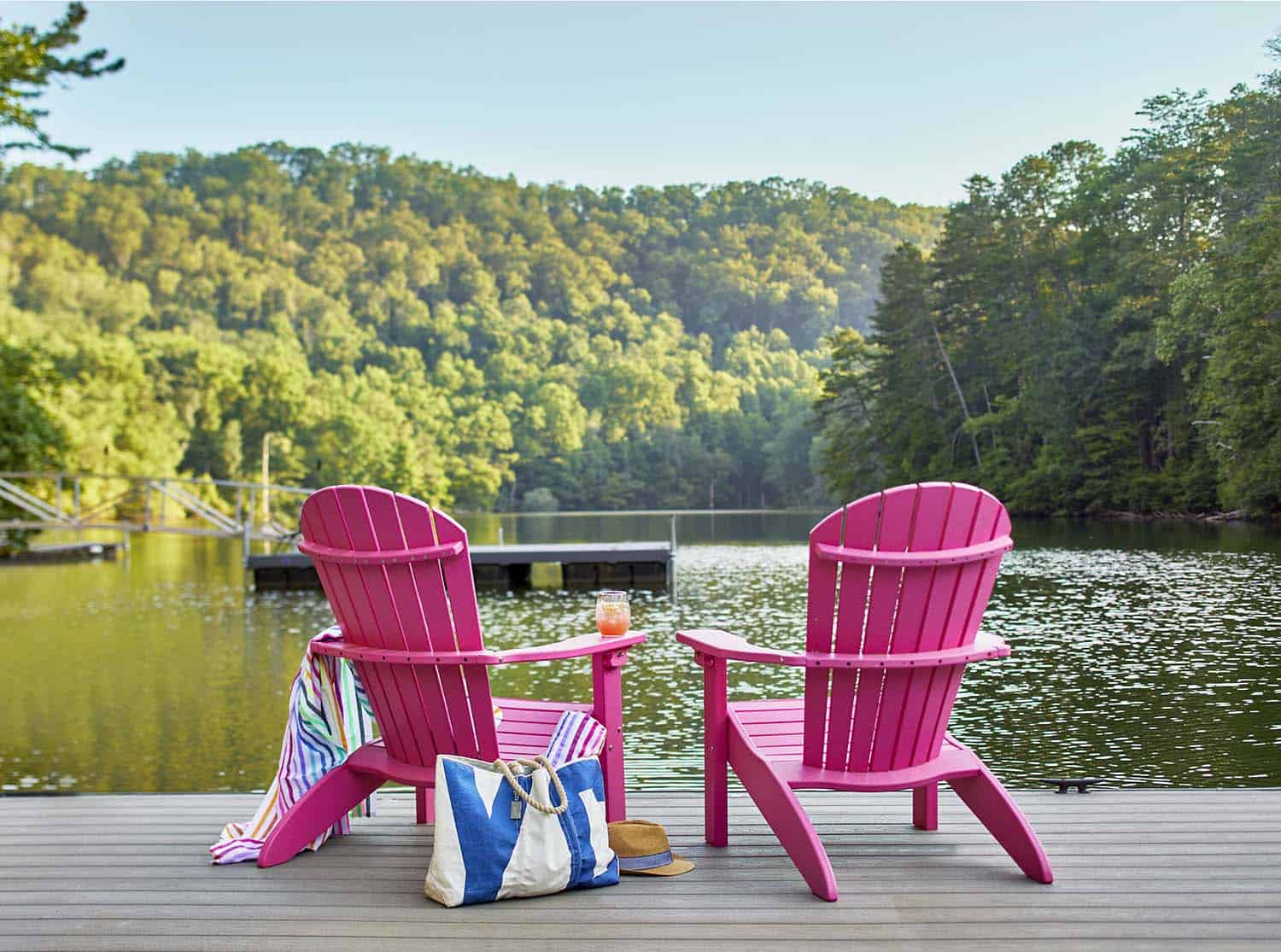rustic-deck-overlooking-a-north-carolina-lake-with-pink-adirondack-chairs
