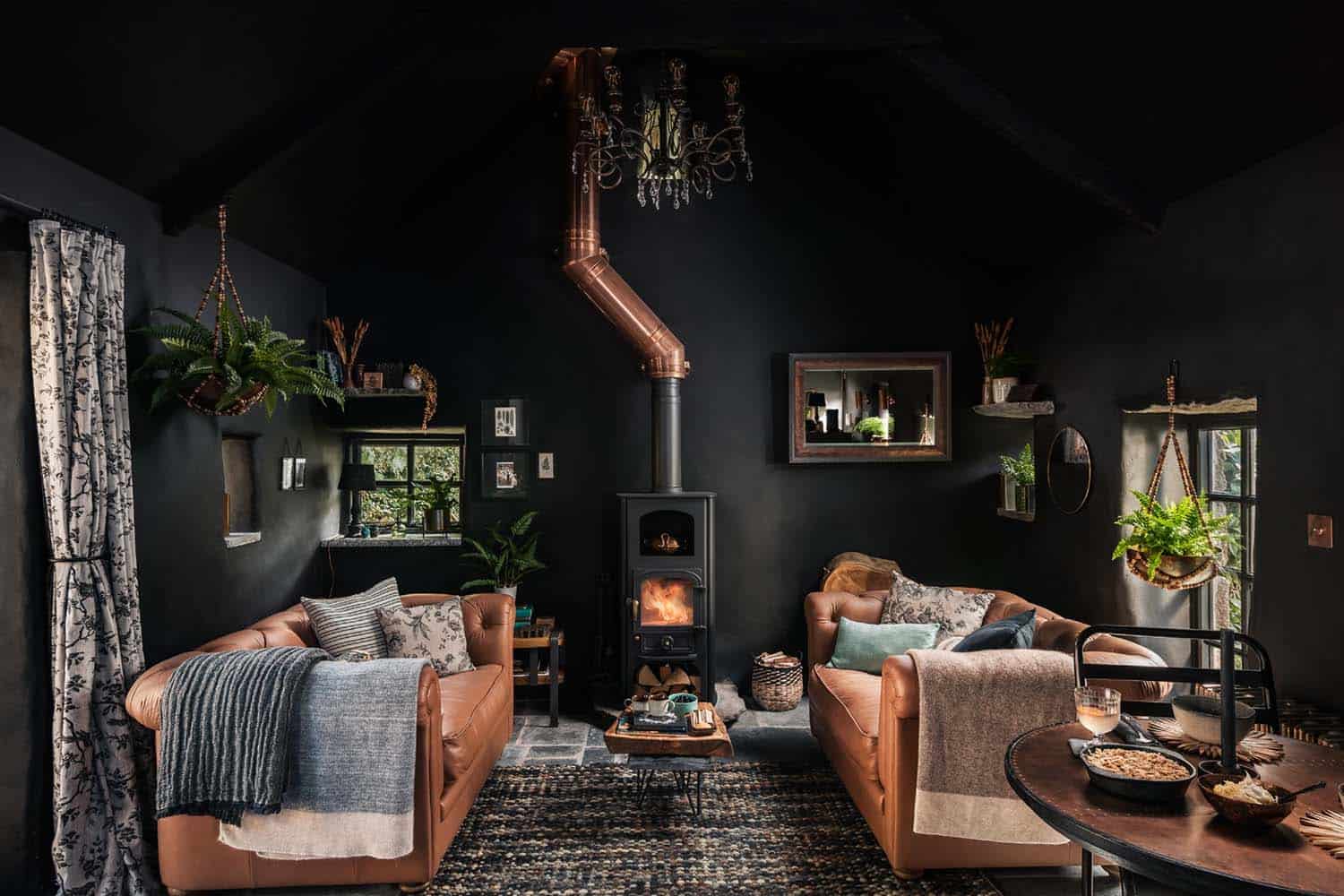 cottage-living-room-with-dark-walls-and-a-wood-burning-stove