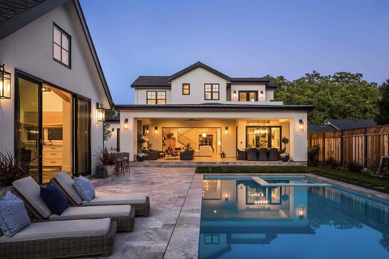 transitional-home-exterior-with-a-pool-at-dusk