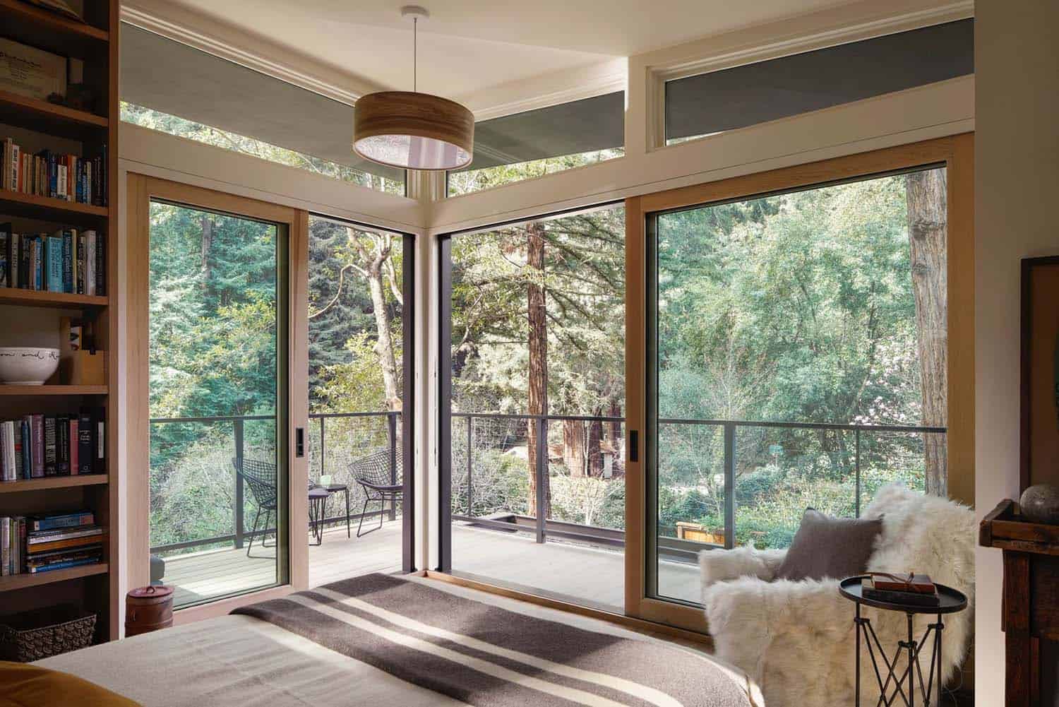 modern-bedroom-with-a-large-window-view-of-the-forest