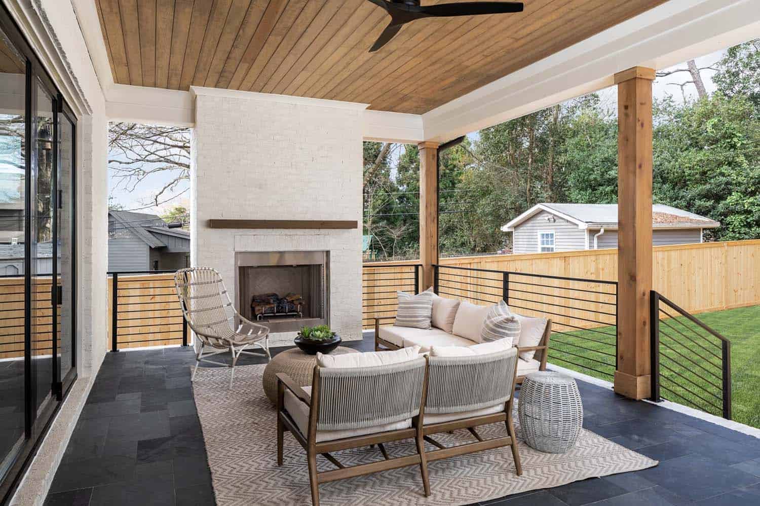 transitional-covered-porch-with-a-fireplace