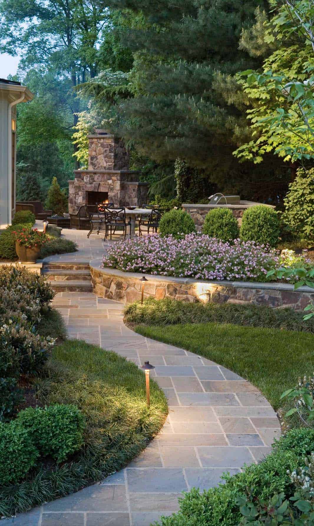 backyard-landscape-with-pathway-lighting-leading-to-a-fireplace
