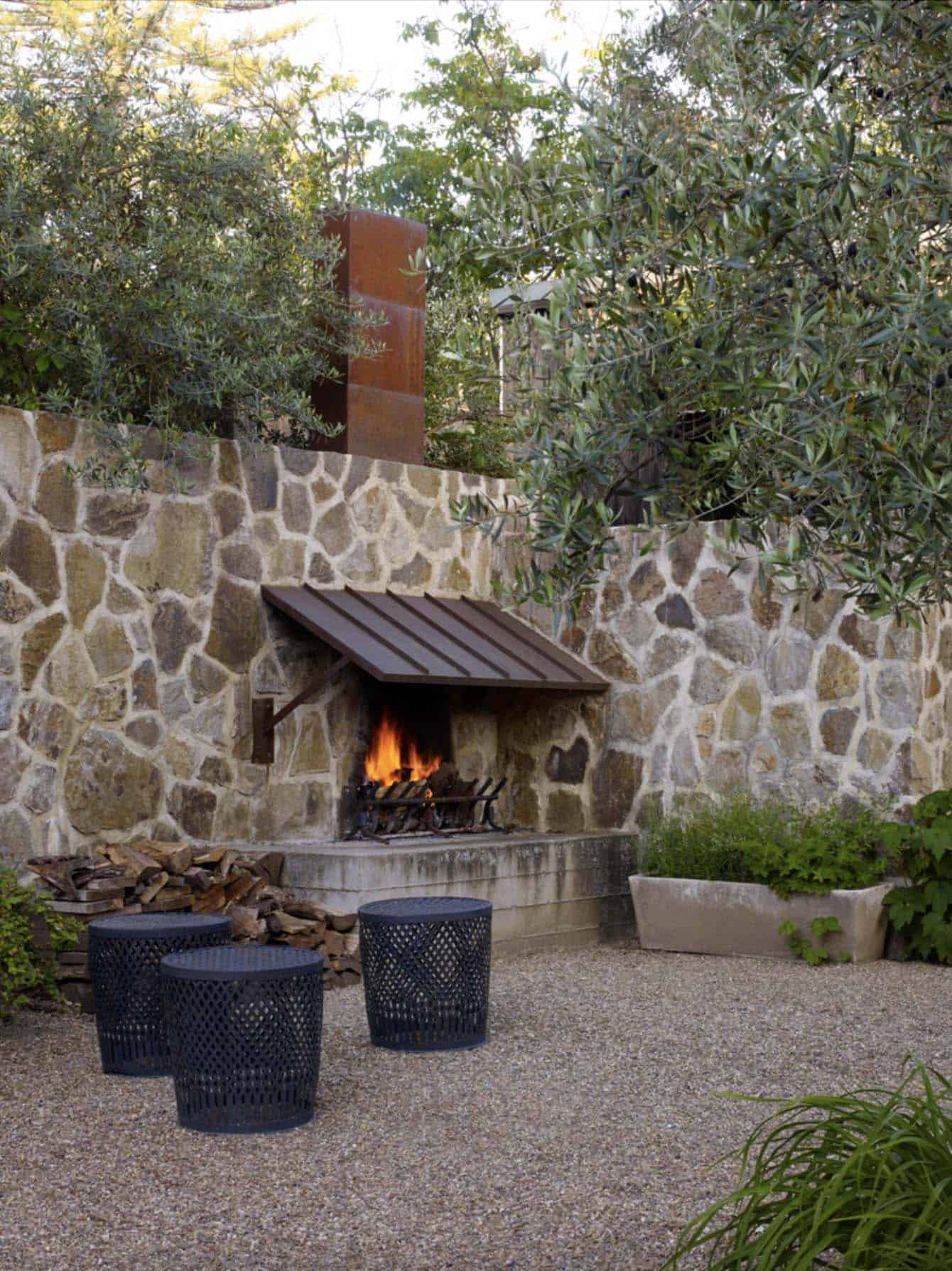 outdoor-fireplace-with-a-stone-wall-and-seating