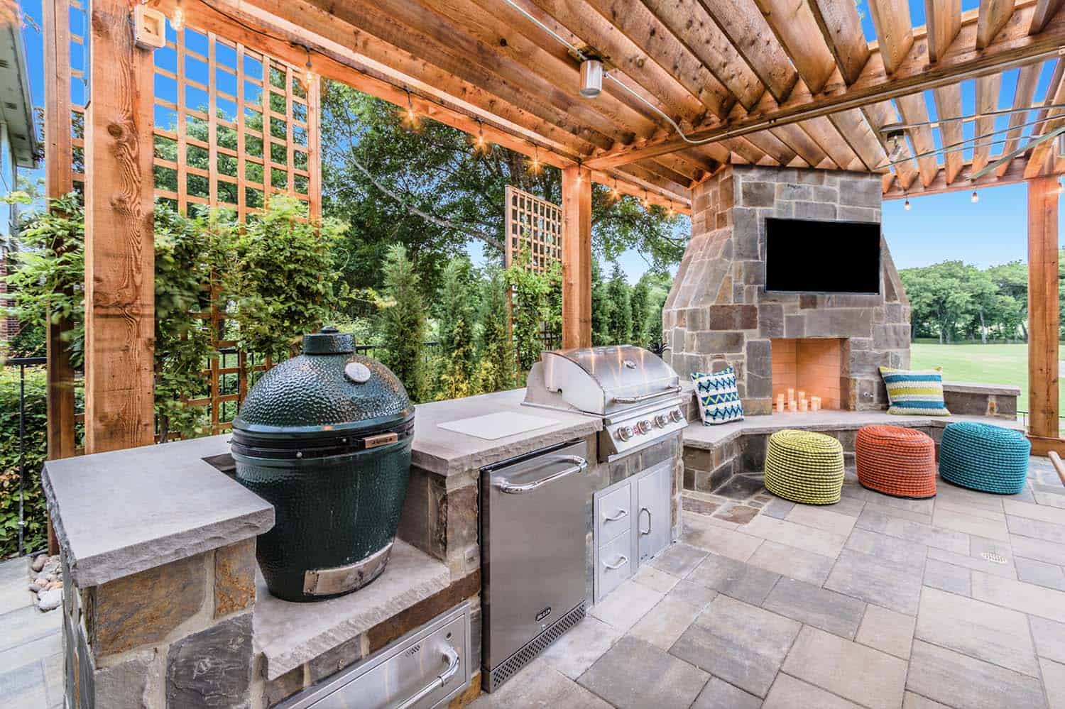 large-outdoor-entertaining-area-with-a-grill-fireplace-and-pergola