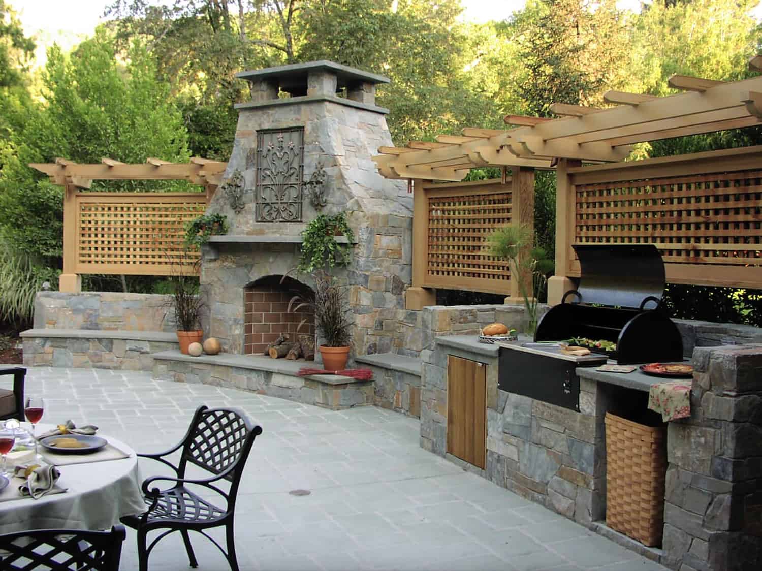 traditional-style-outdoor-kitchen-with-a-pergola-and-fireplace